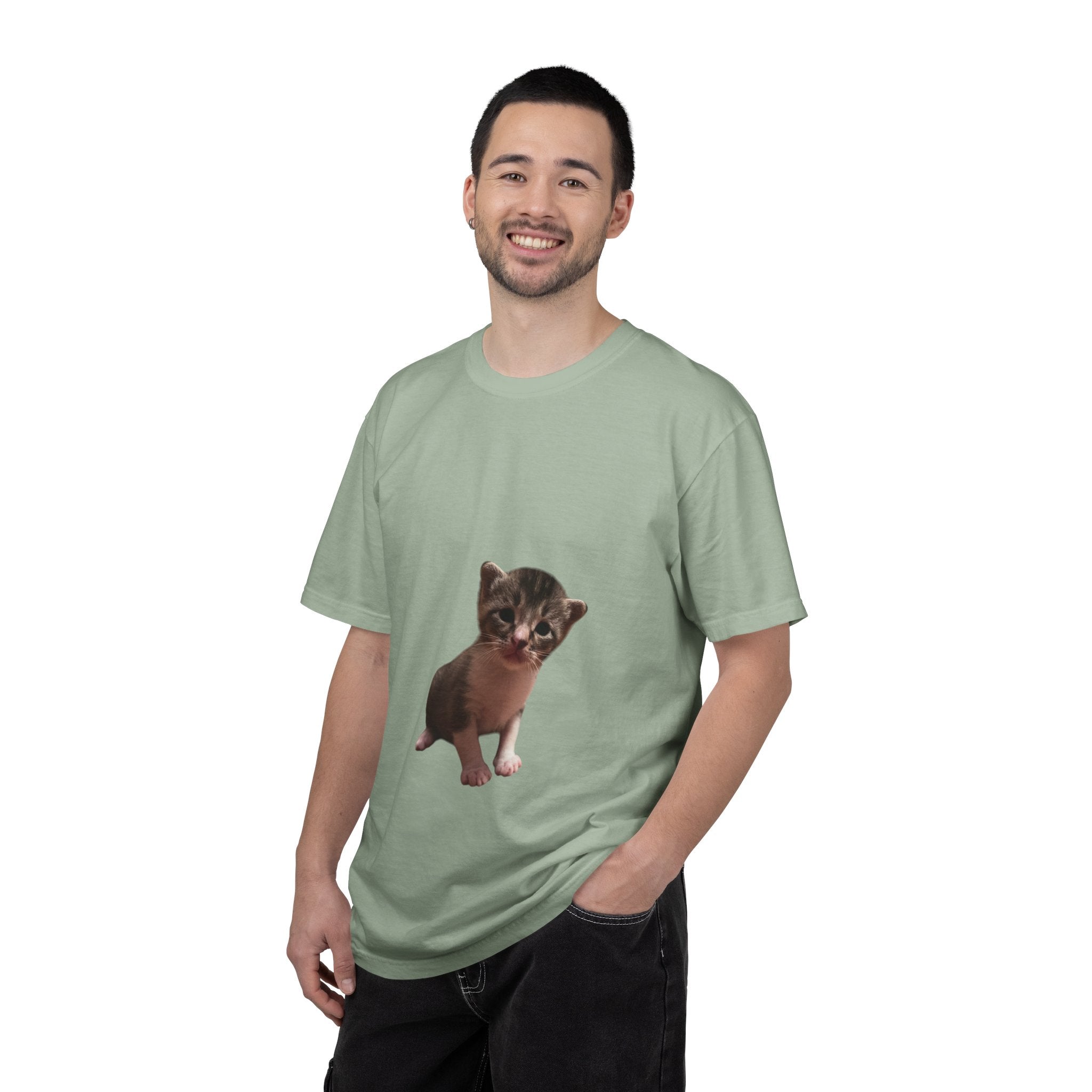 Man wearing a light green t-shirt with a cat graphic on a white background