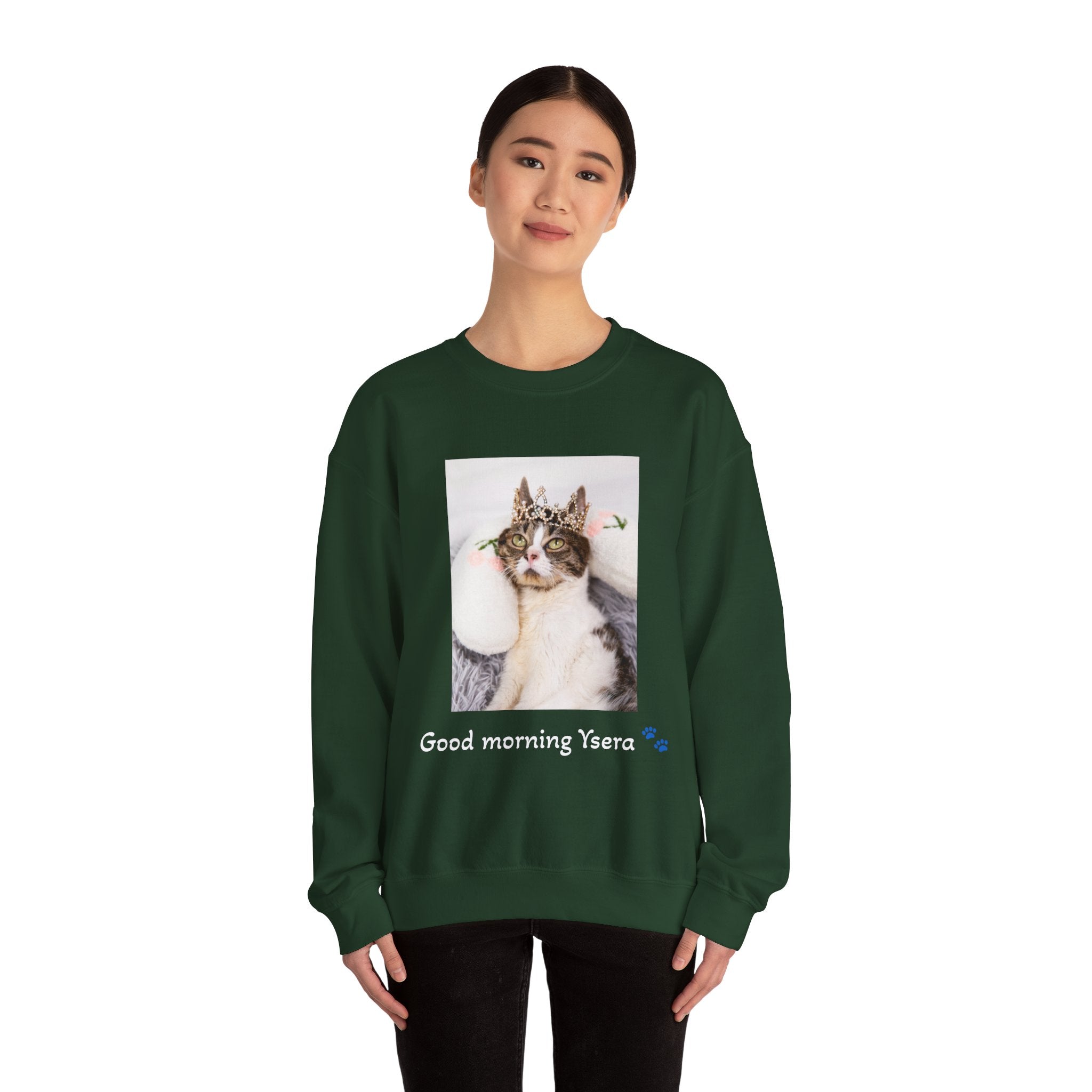 Person wearing a green sweatshirt with a cat graphic and text on a white background