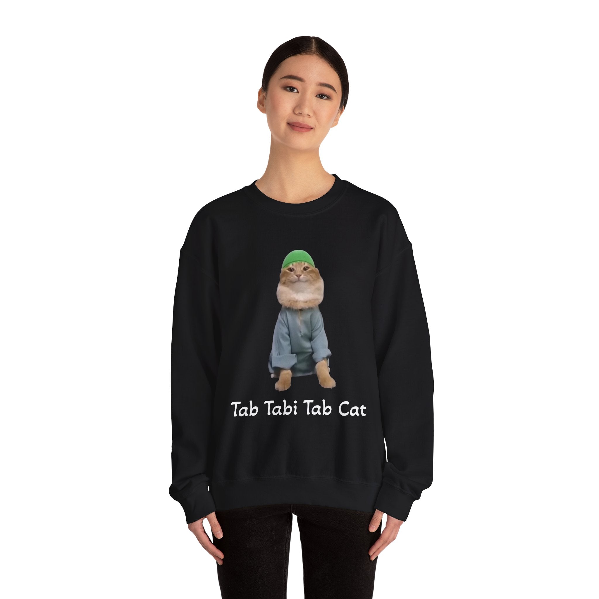 Person wearing a black sweatshirt with a cat graphic and text on a white background