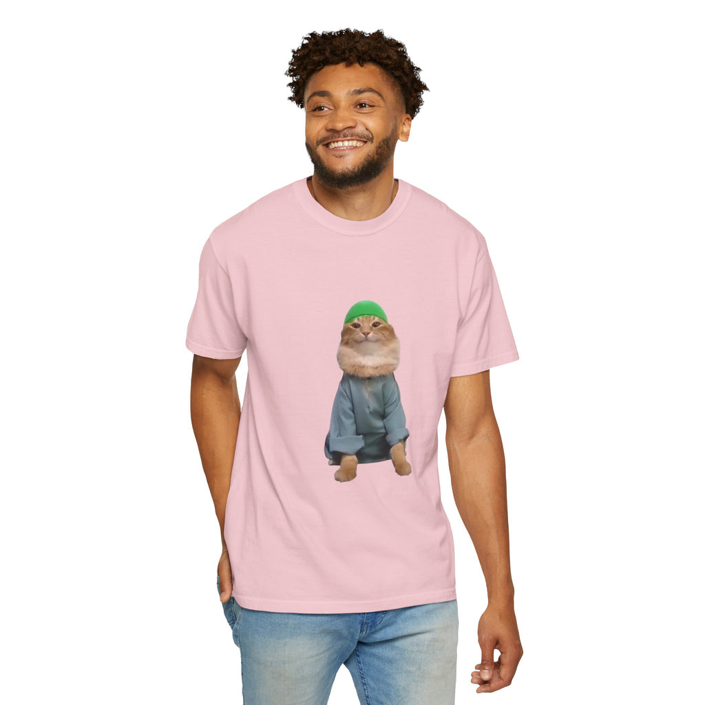 Person wearing a pink t-shirt with a graphic of a cat in a green hat and blue jacket on a white background