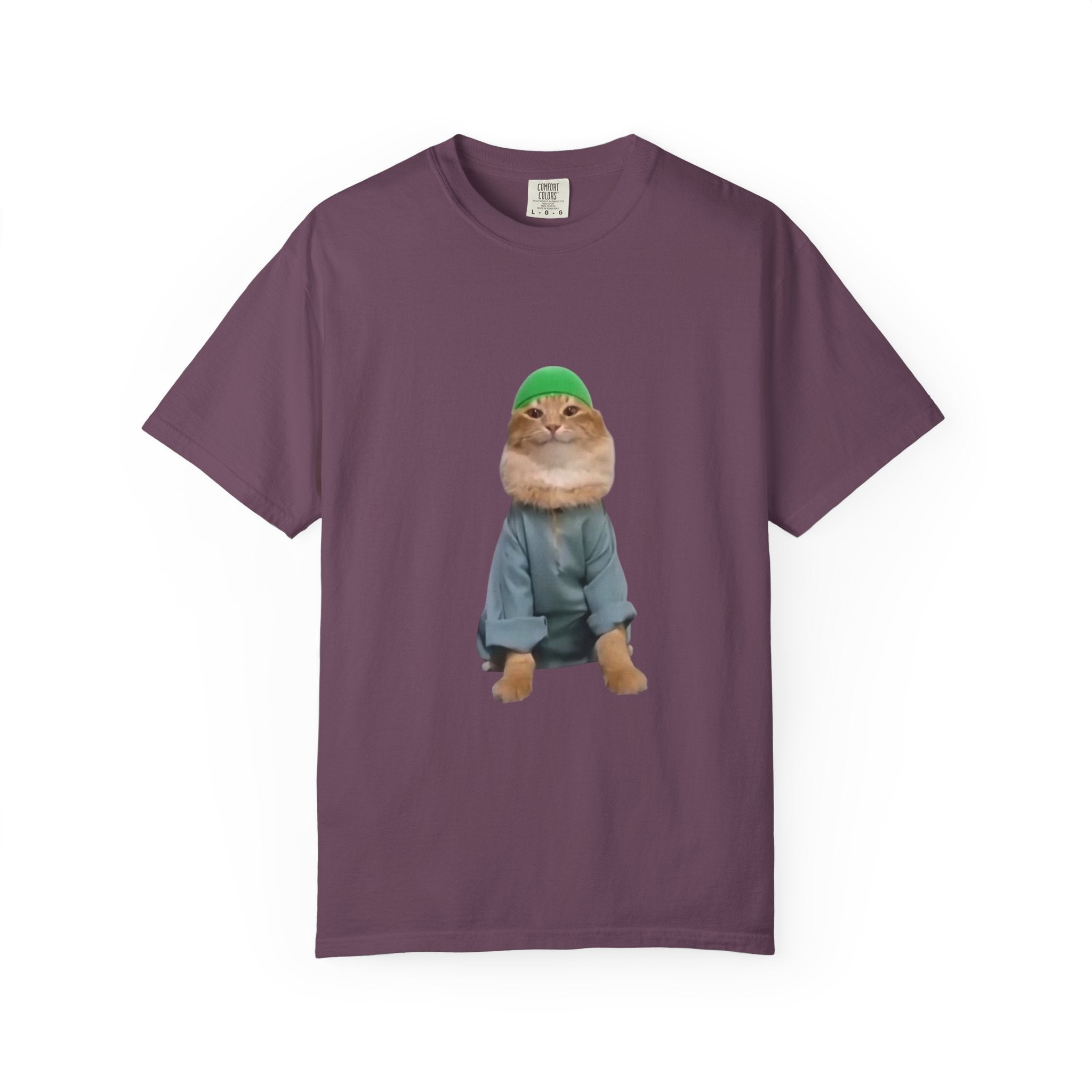 Purple t-shirt with a graphic of a cat wearing a green hat and blue jacket on a white background