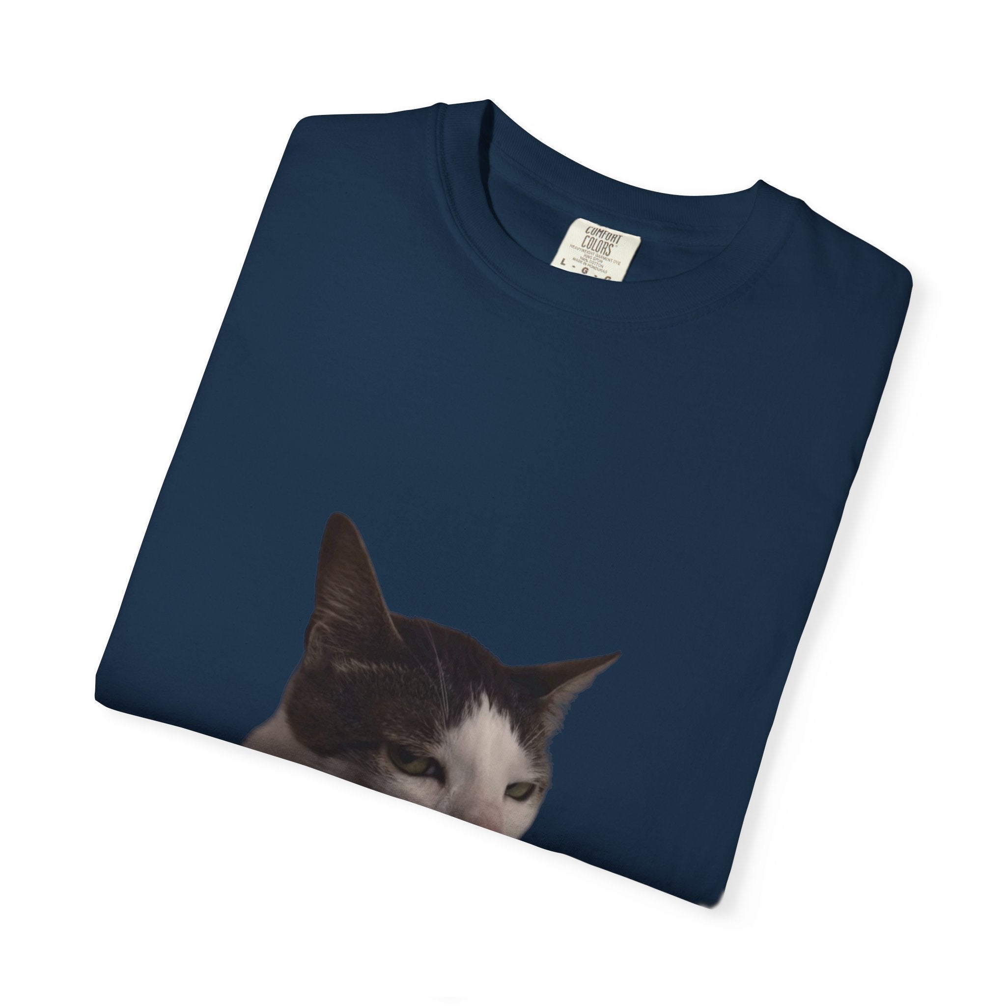 Folded navy blue t-shirt with a cat's face print on a white background
