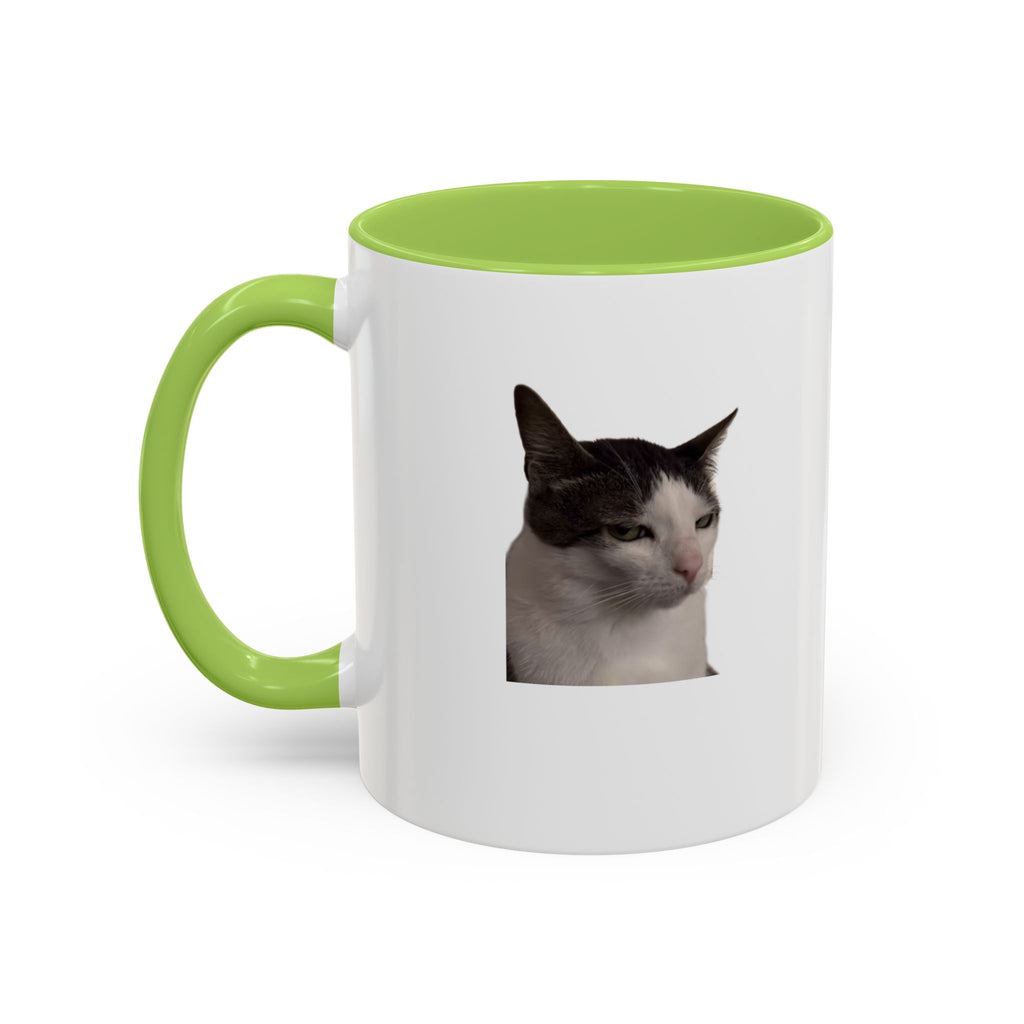 White mug with green handle and interior, featuring a cat's face on a white background
