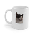 White mug with a cat's face printed on it against a white background