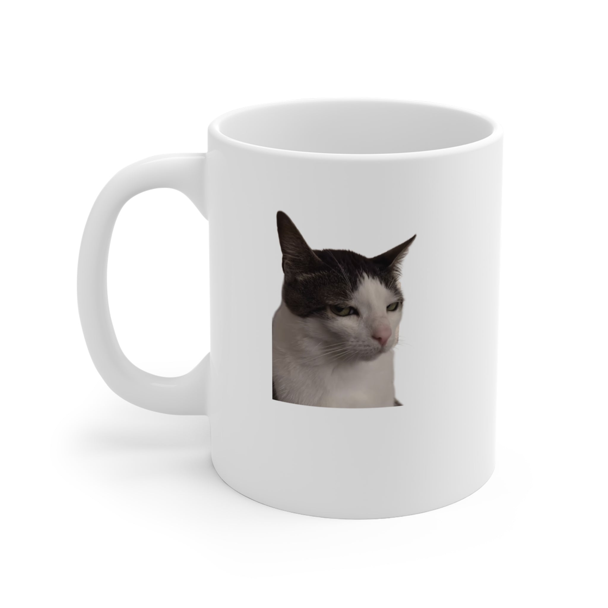 White mug with a cat's face printed on it against a white background