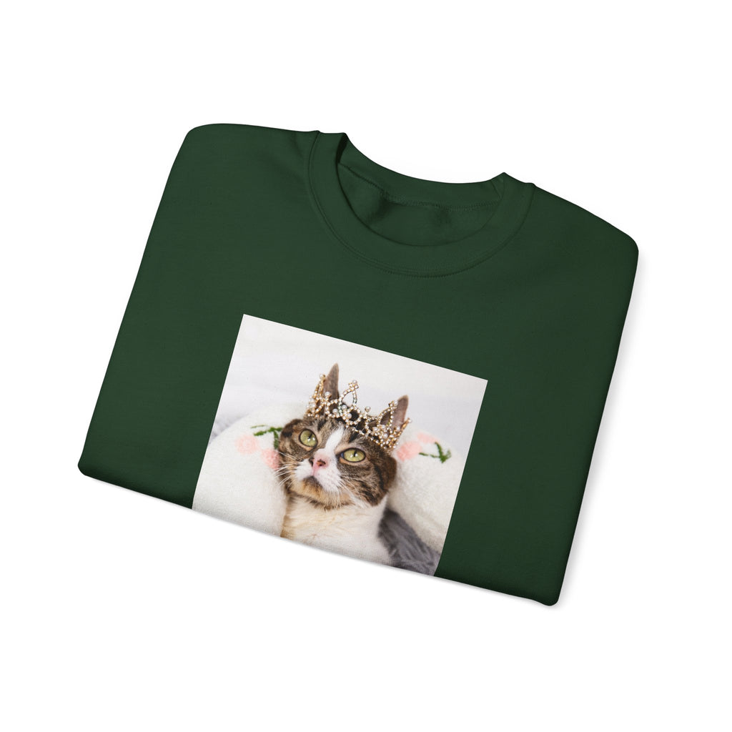 Green sweatshirt with a cat wearing a crown printed on it, on a white background