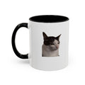 White mug with black handle featuring a cat's face on a white background