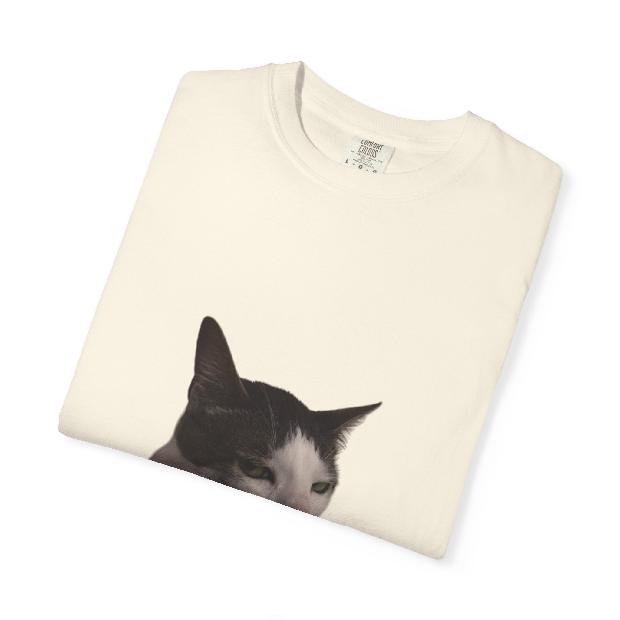 Folded white t-shirt with a black and white cat print on a white background