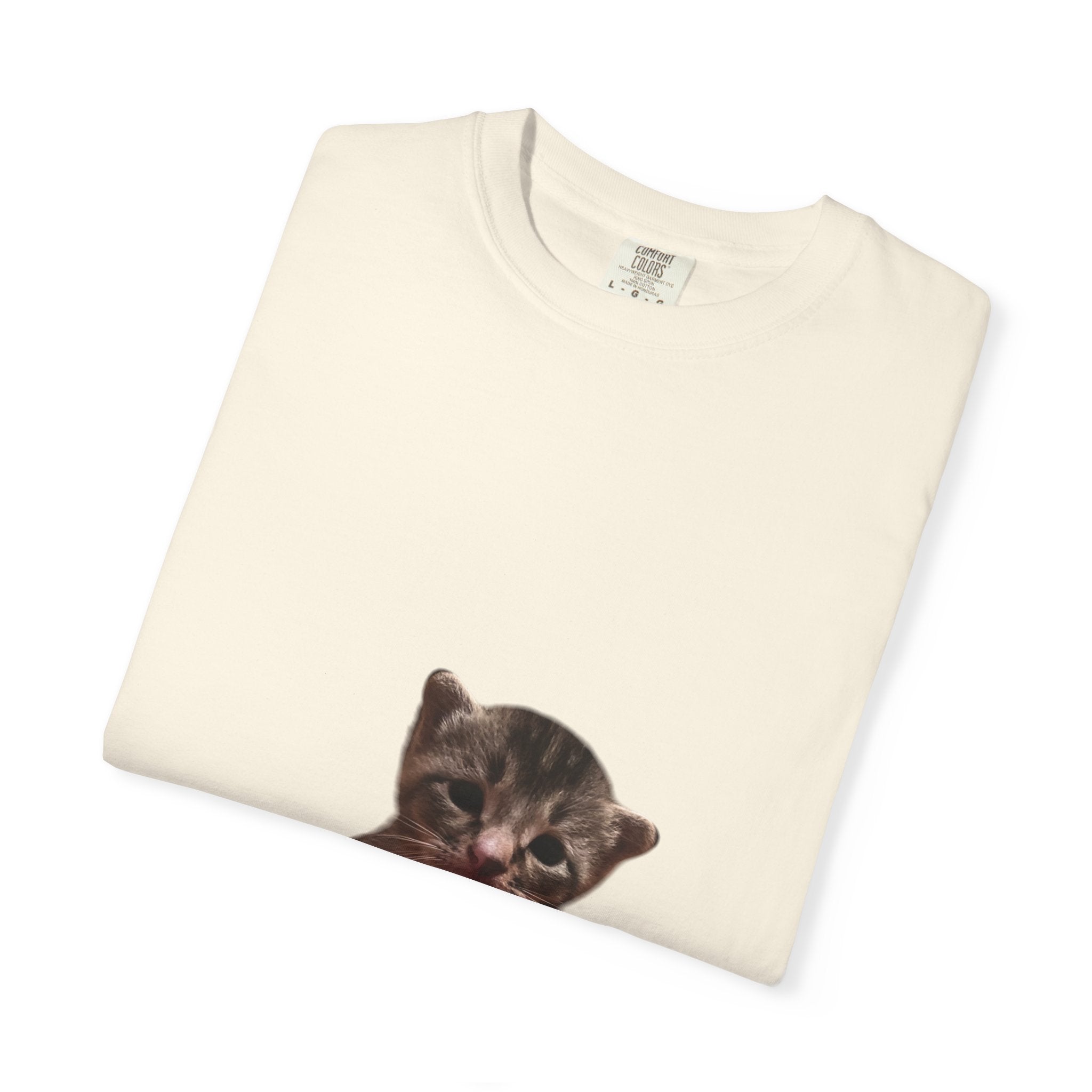 Folded cream-colored sweatshirt with a cat face print on a white background