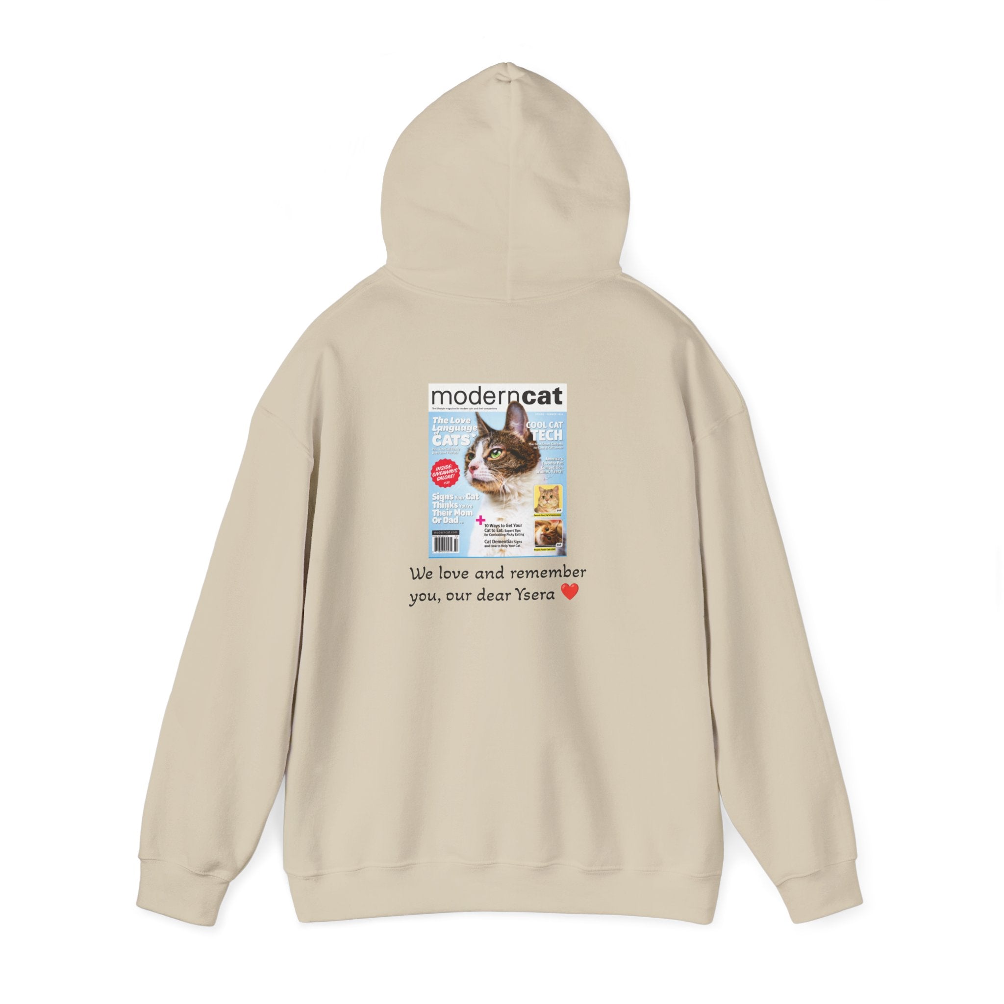 Beige hoodie with a printed design on the chest featuring a cat magazine cover and text.