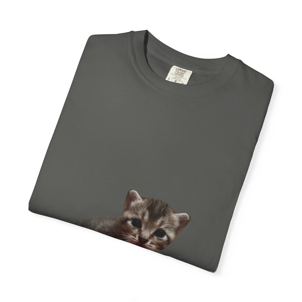 Folded dark gray t-shirt with a kitten graphic on a white background