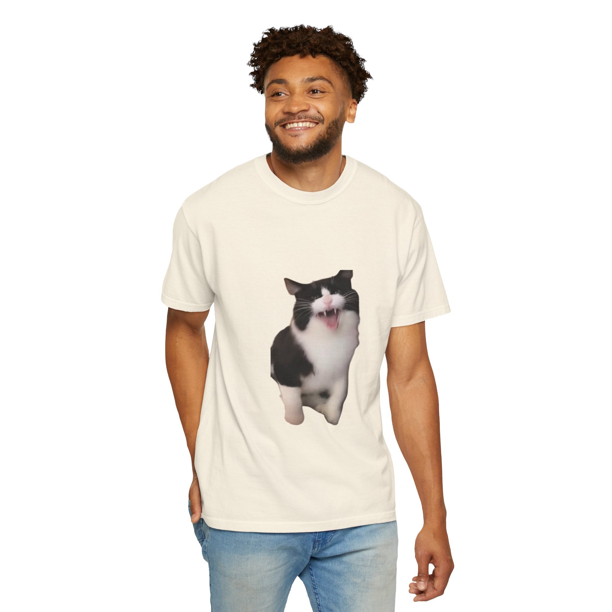 Man wearing a cream t-shirt with a cat graphic on a white background
