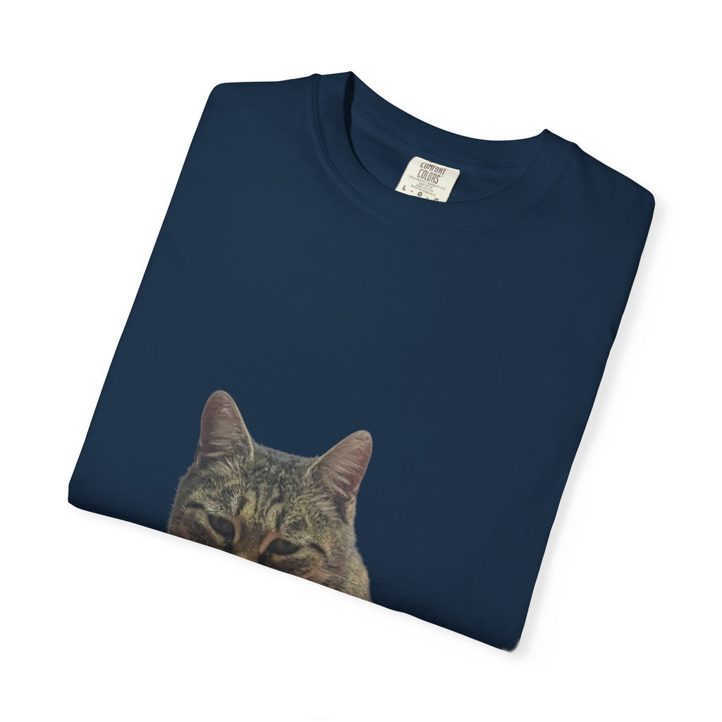 Folded navy blue t-shirt with a cat face print on a white background