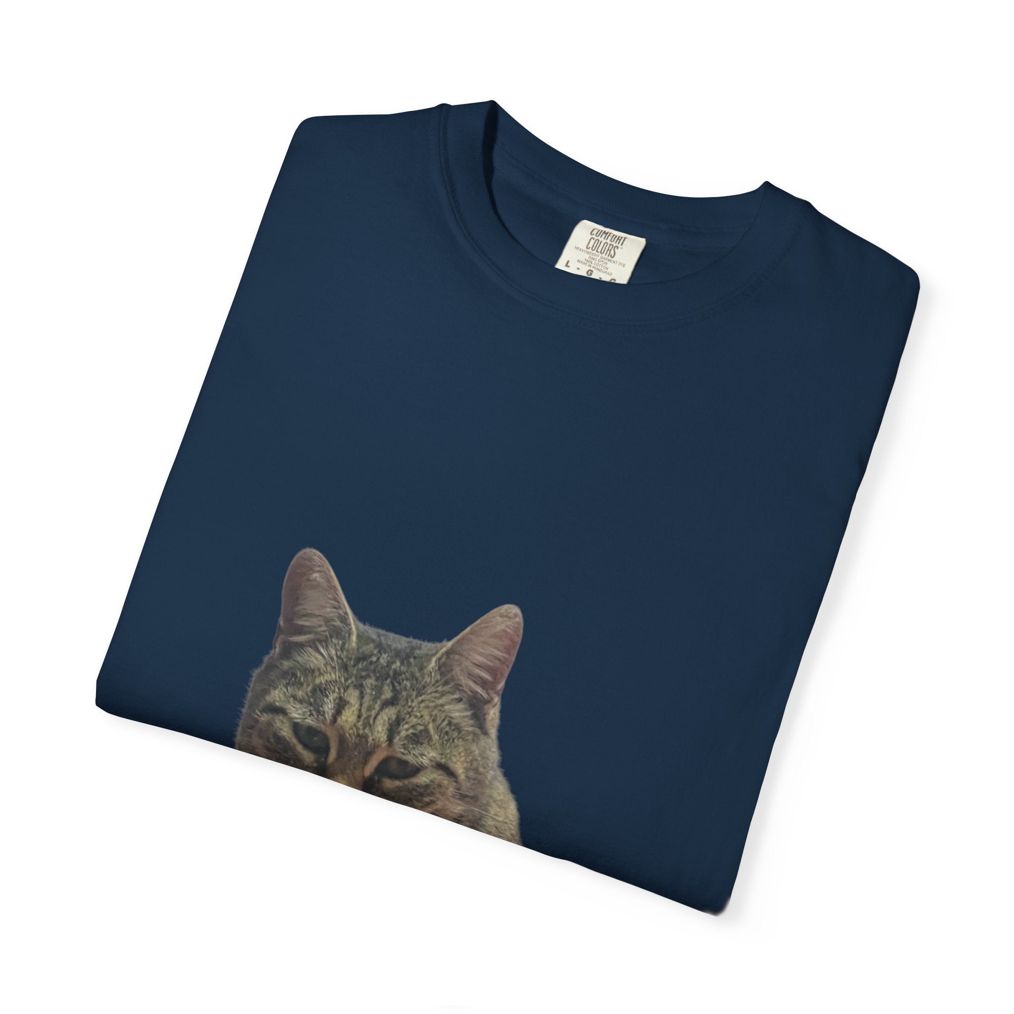Folded navy blue t-shirt with a cat face print on a white background