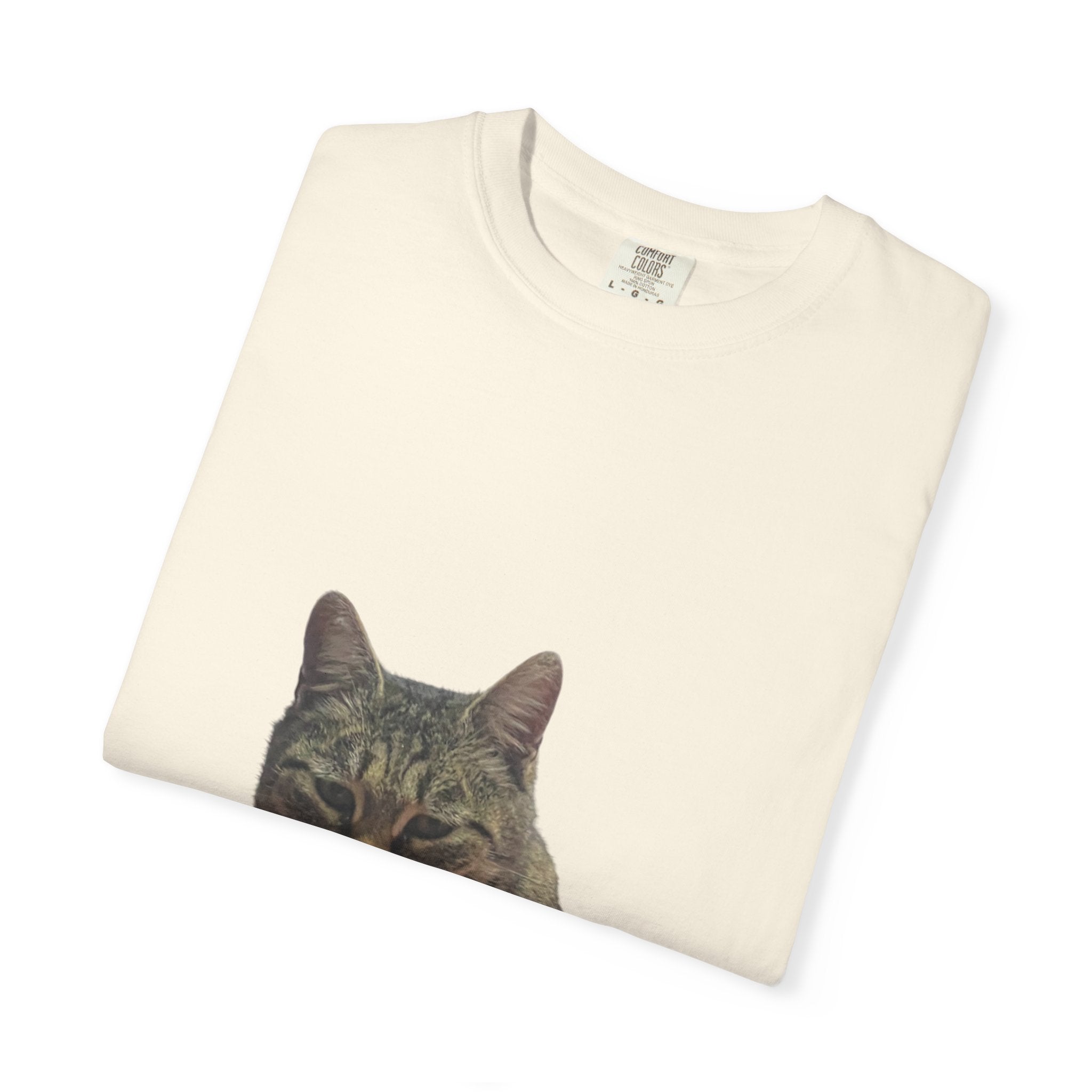 Folded cream-colored sweatshirt with a cat face print on a white background