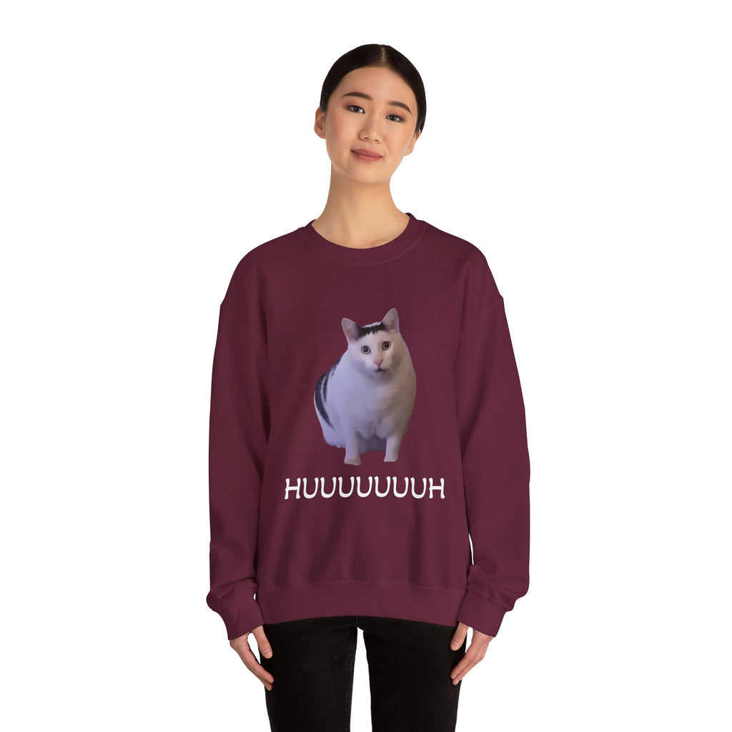Person wearing a maroon sweatshirt with a cat graphic and text on a white background