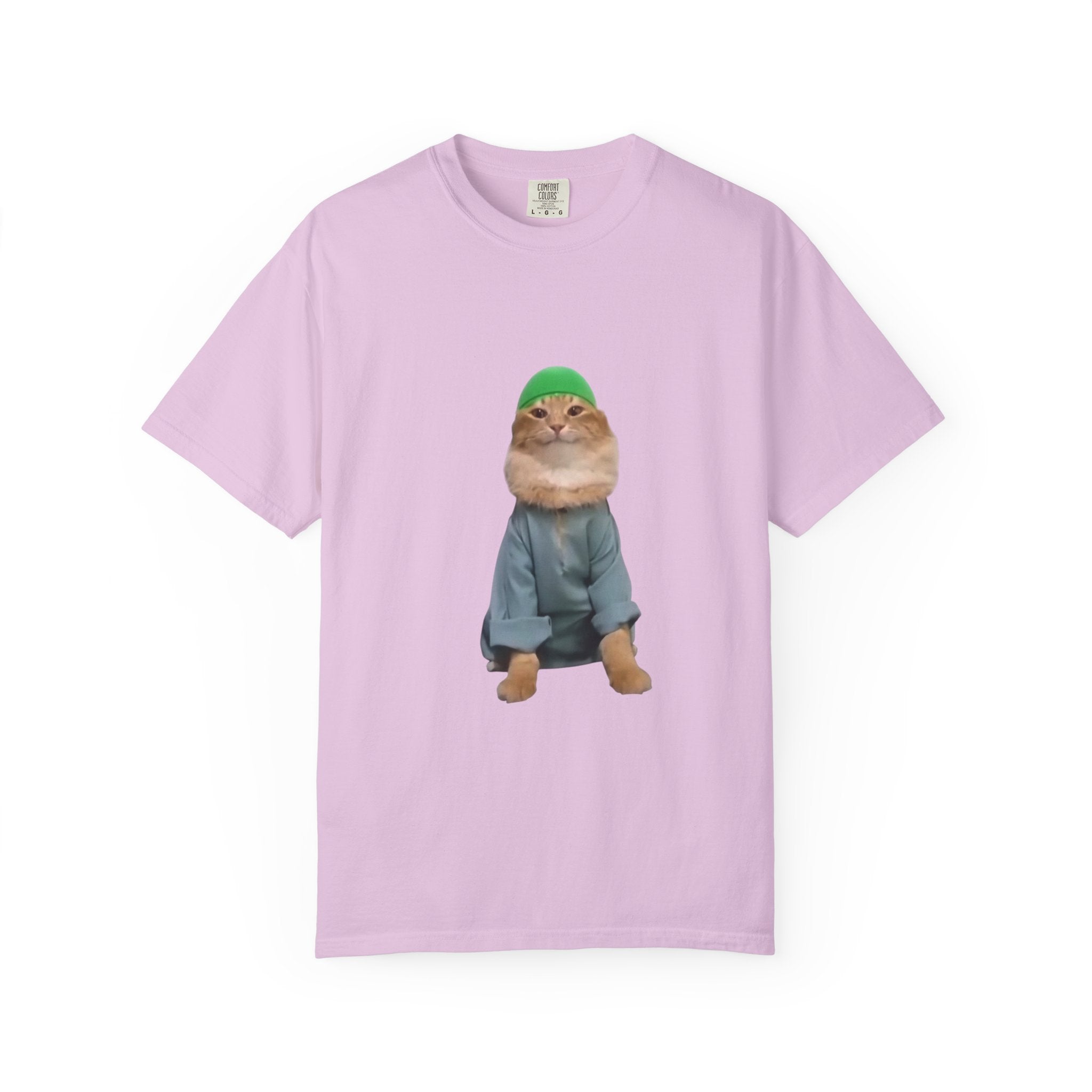 Pink t-shirt with a graphic of a cat wearing a green hat and blue coat on a white background