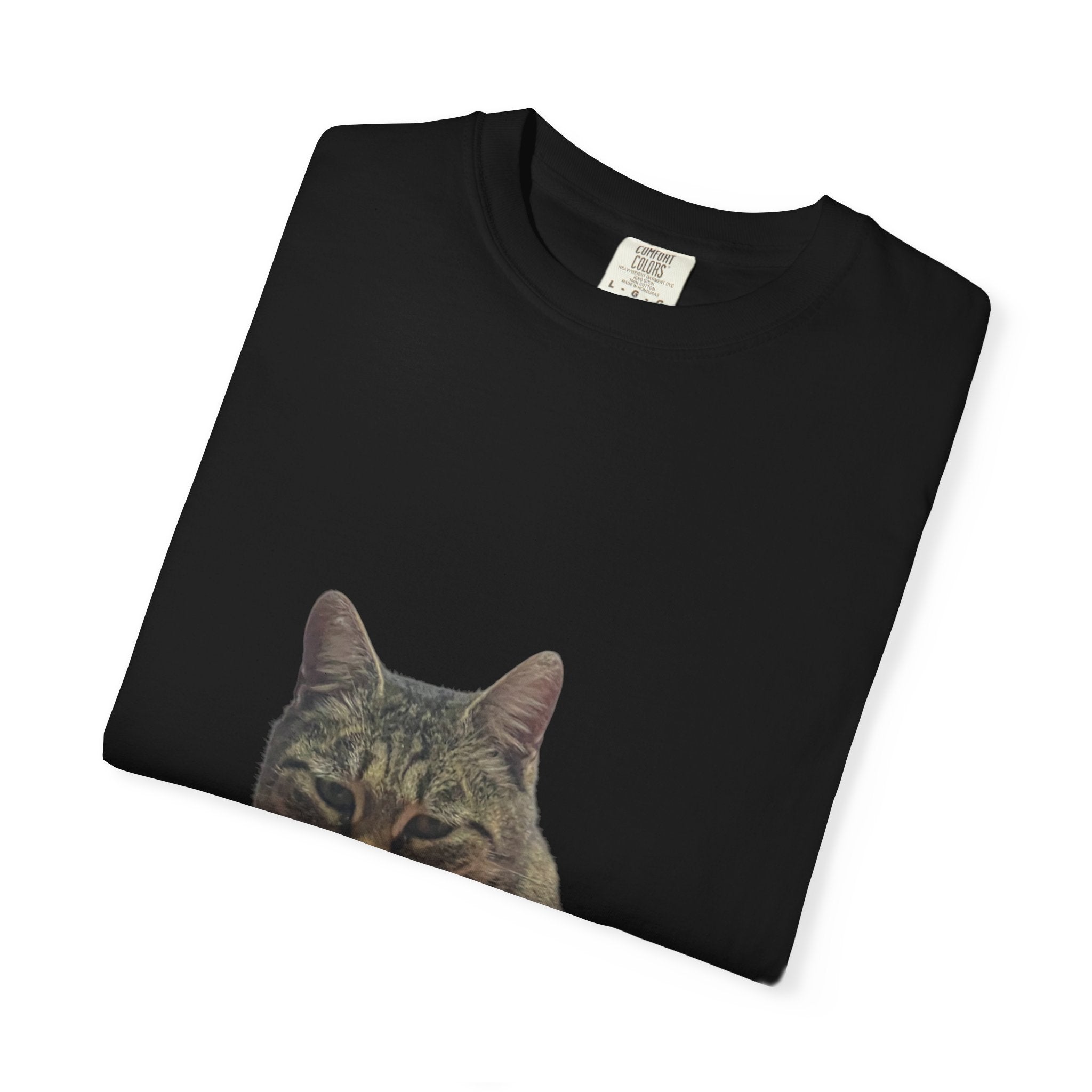 Black t-shirt with a cat's face printed on it, folded on a white background