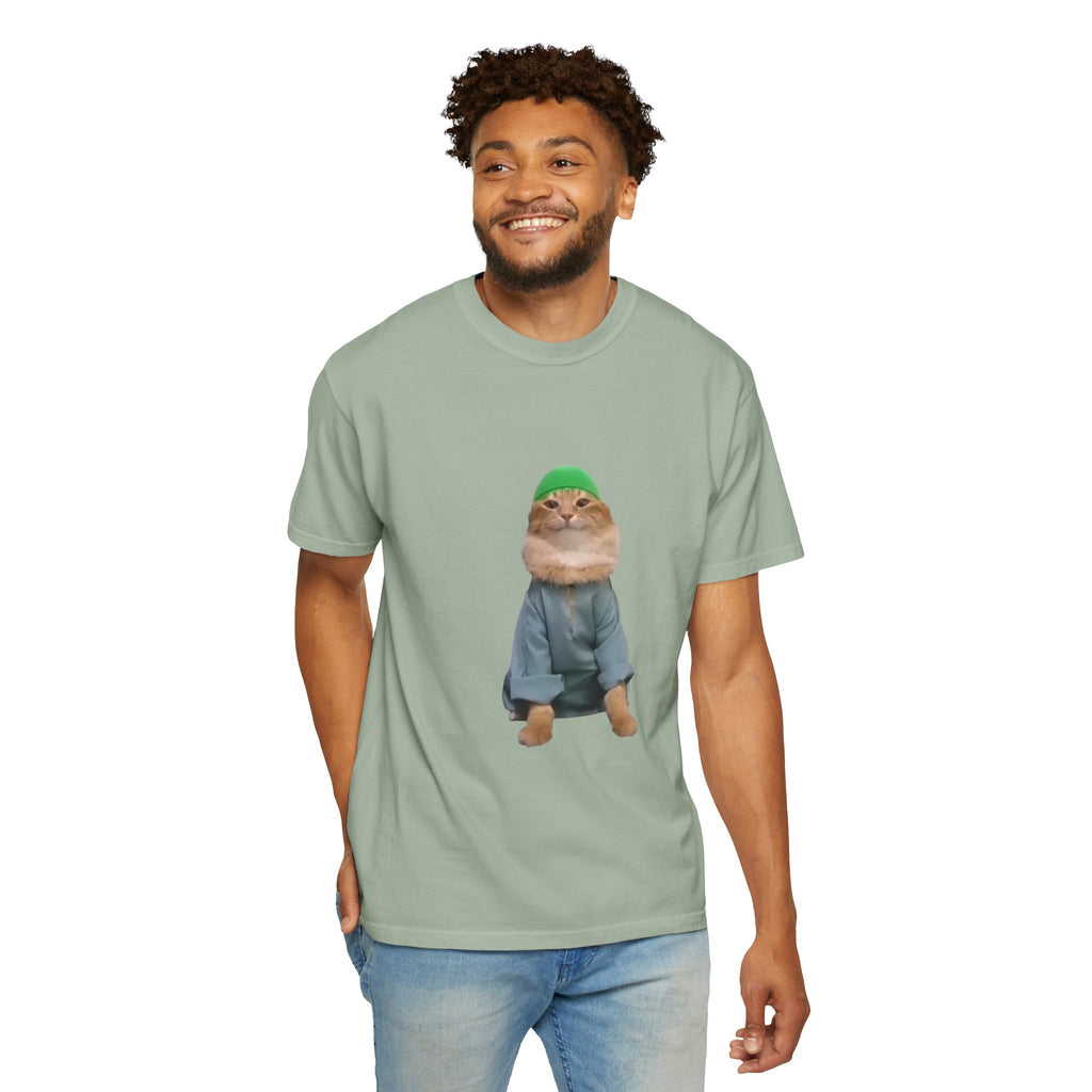 Man wearing a light green t-shirt with a graphic of a cat in a hat and coat on a white background
