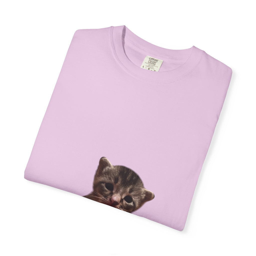 Folded light purple t-shirt with a kitten graphic on a white background