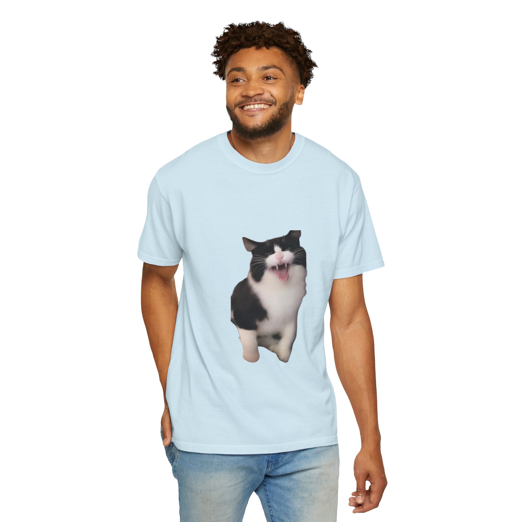Man wearing a light blue t-shirt with a cat graphic on a white background