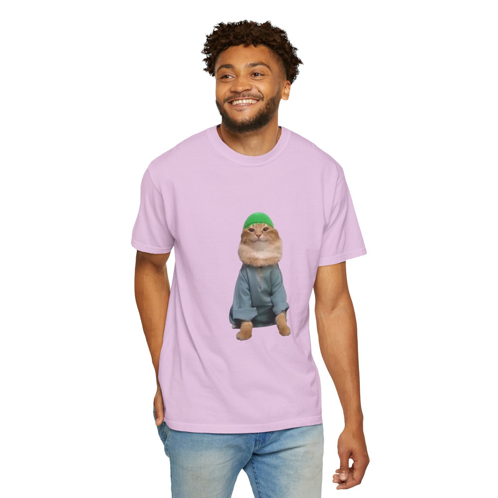 Person wearing a light purple t-shirt with a graphic of a cat in a green hat and blue jacket on a white background