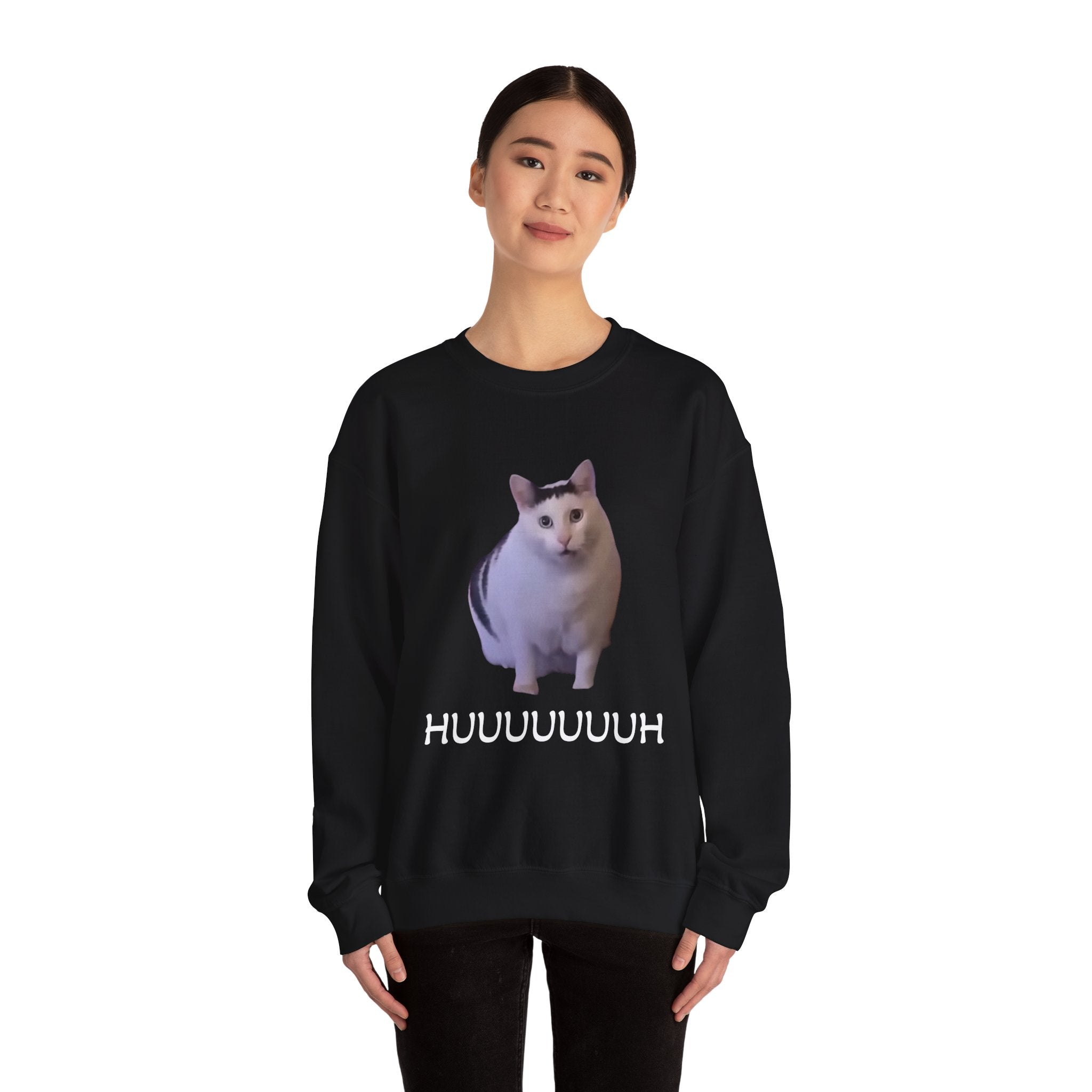 Person wearing a black sweatshirt with a cat graphic and text on a white background