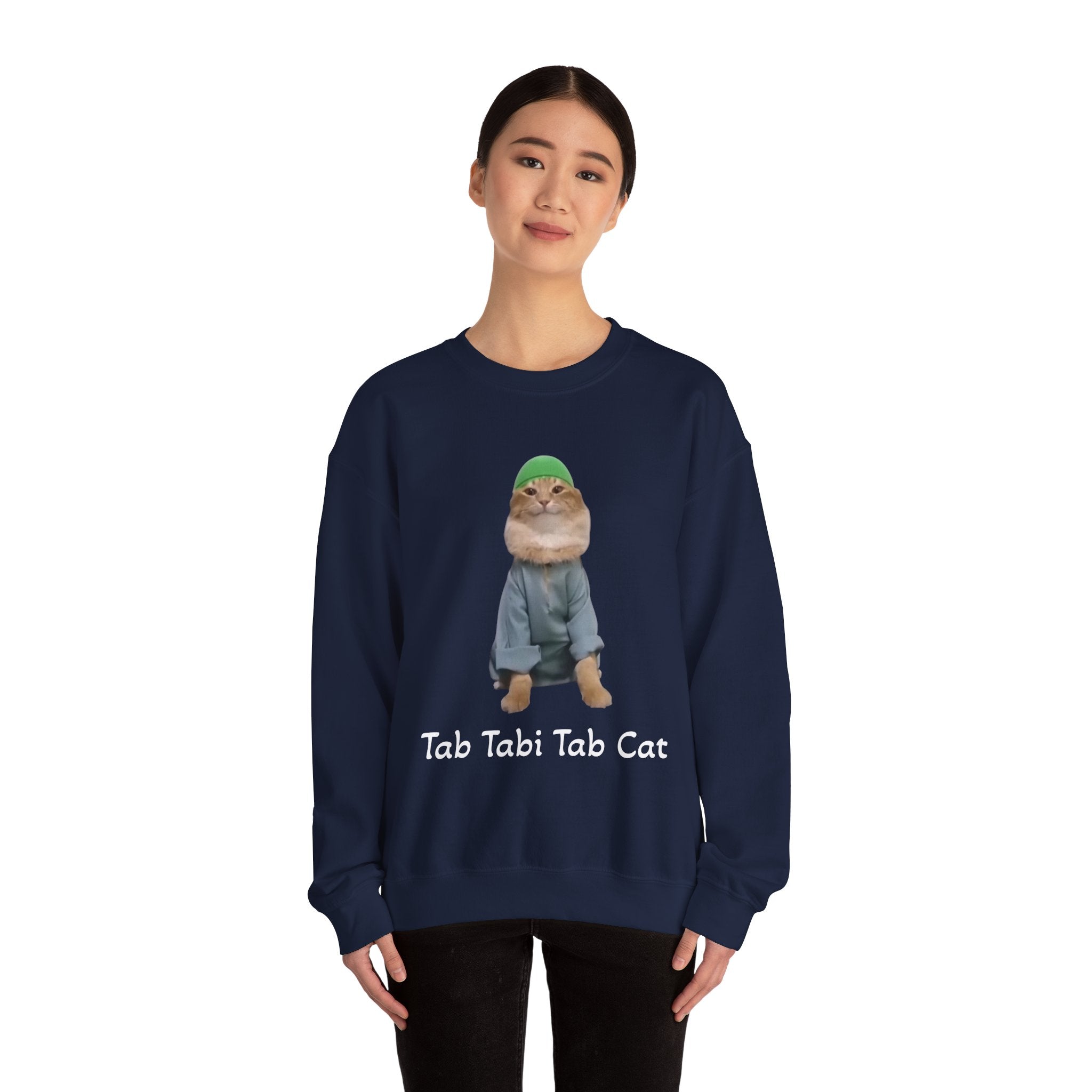 Person wearing a navy blue sweatshirt with a cat graphic and text on a white background