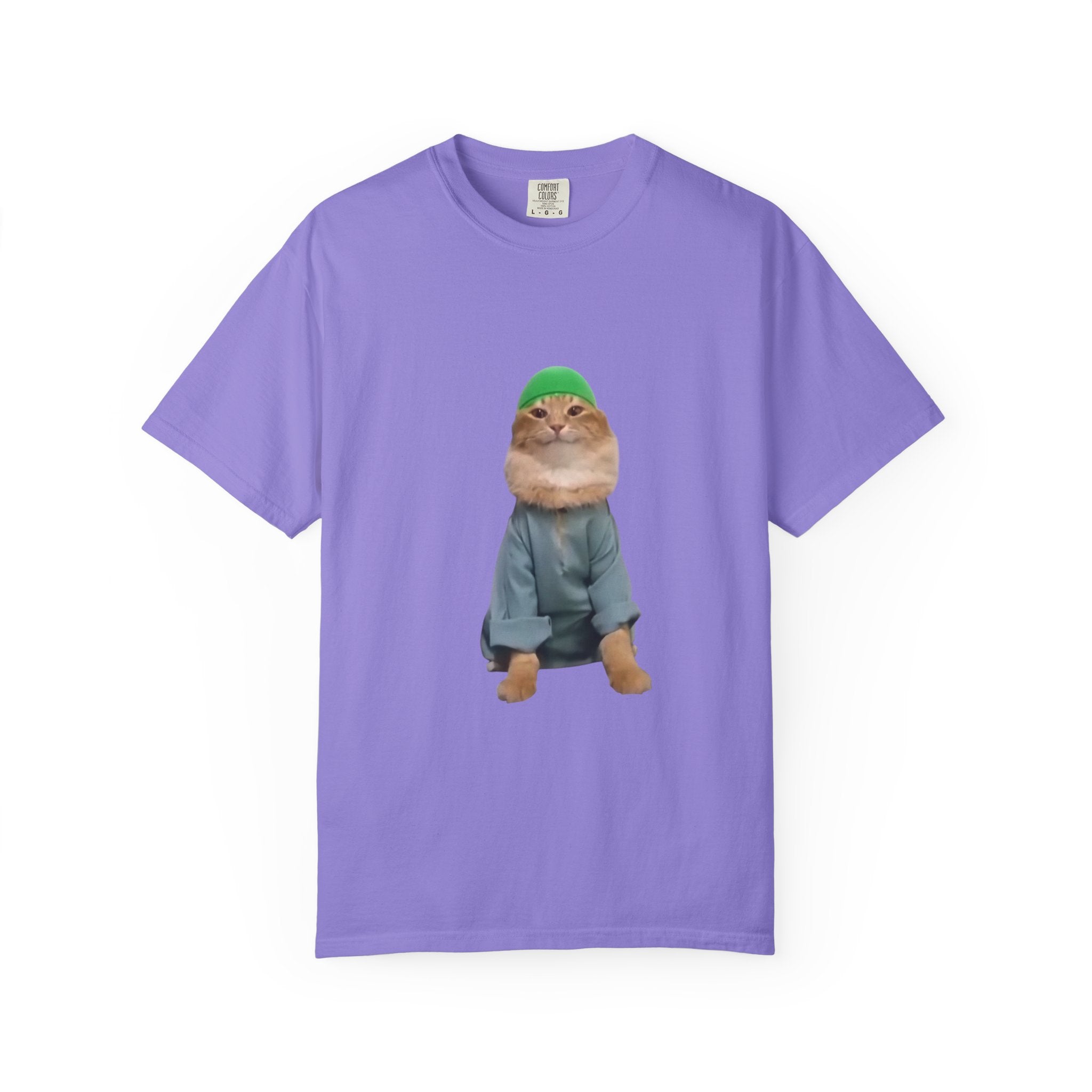 Purple t-shirt with a graphic of a cat wearing a green hat and coat on a white background