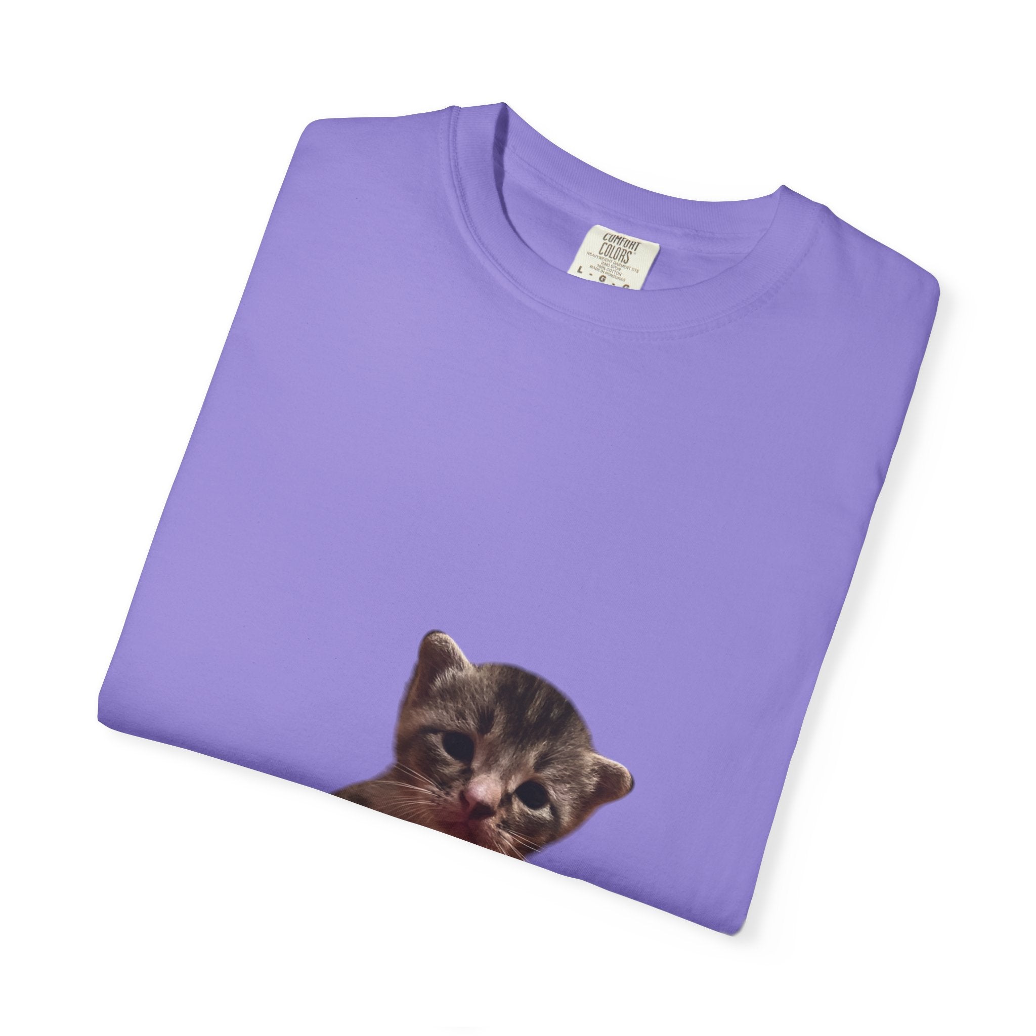 Folded purple t-shirt with a kitten graphic on a white background
