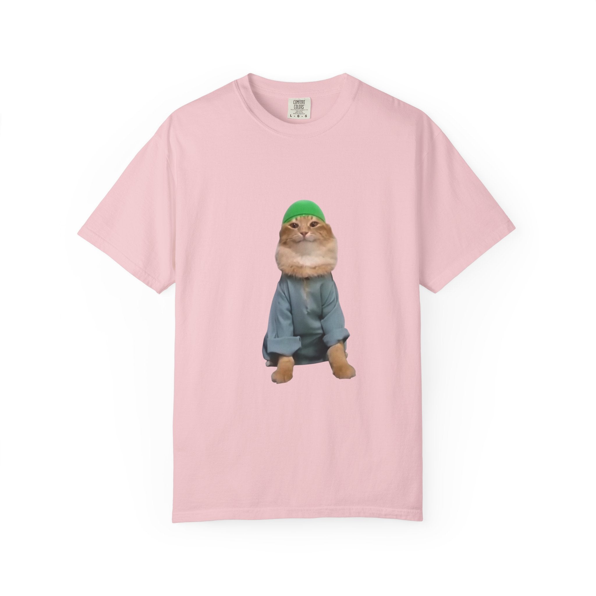 Pink t-shirt with a graphic of a cat wearing a green hat and blue coat on a white background