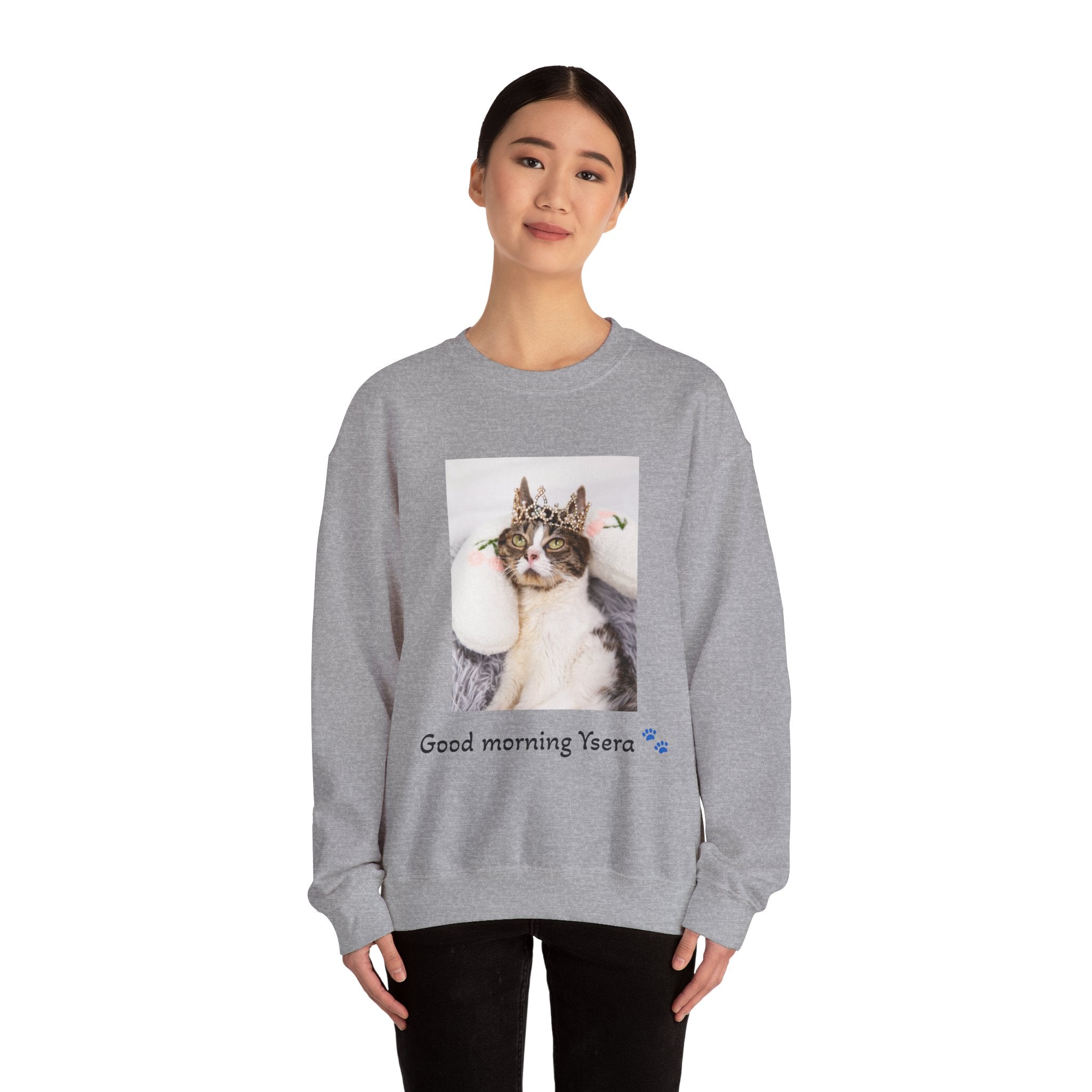 Person wearing a gray sweatshirt with a cat graphic and text on a white background