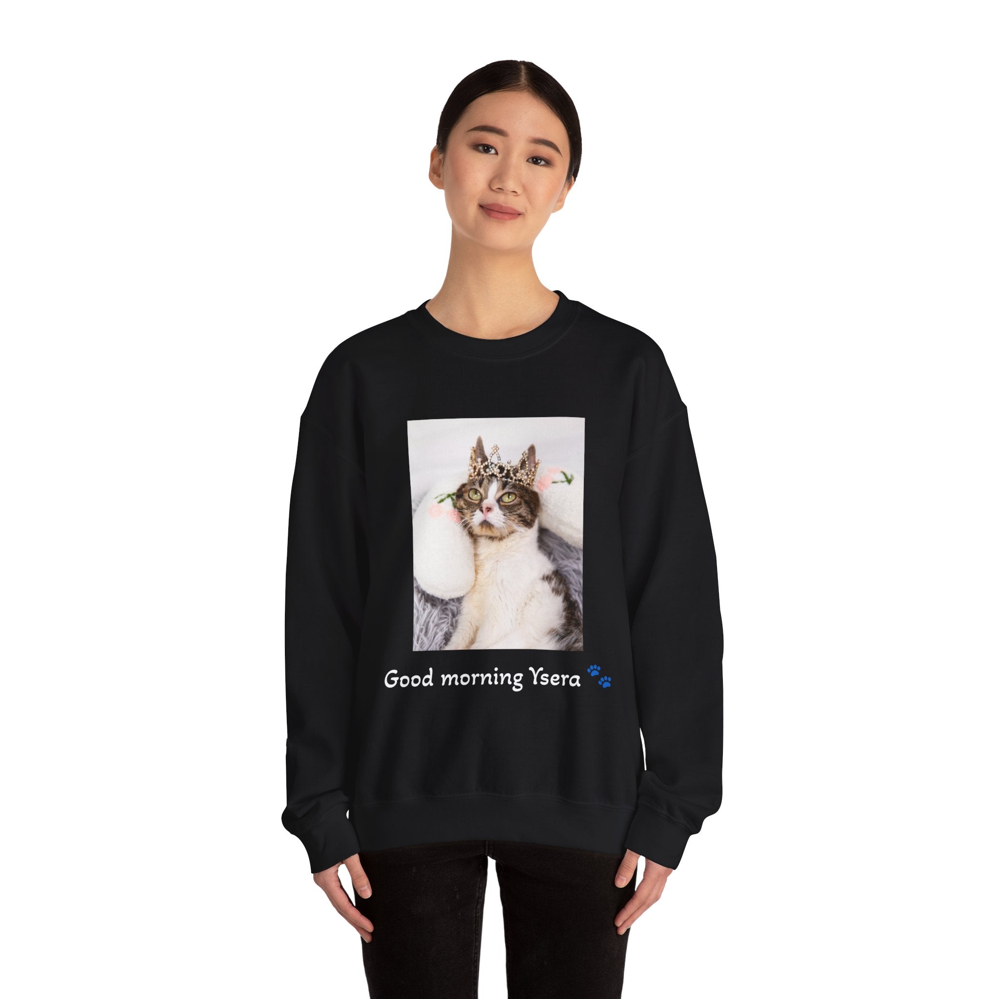 Person wearing a black sweatshirt with a cat graphic and text on a white background