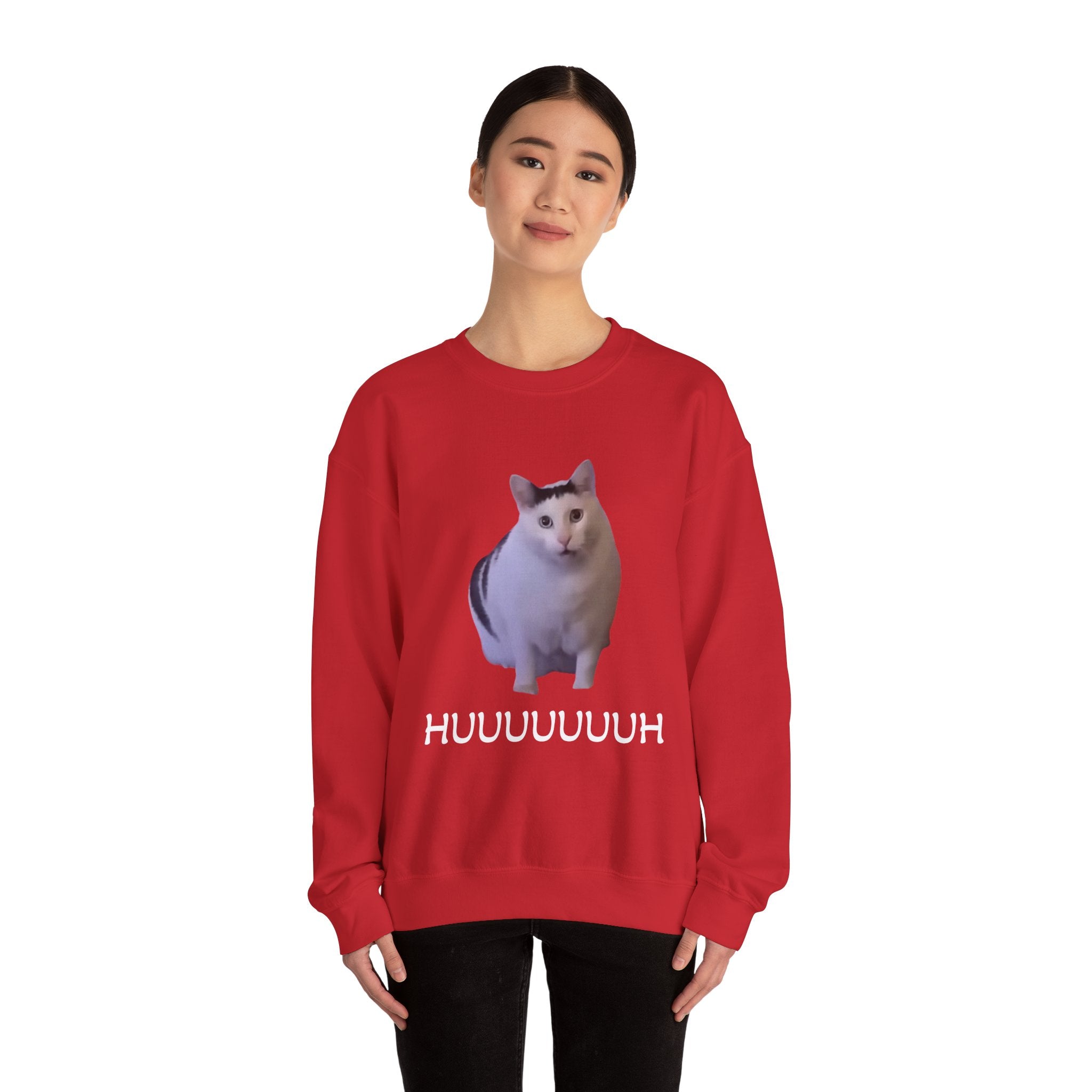 Person wearing a red sweatshirt with a cat graphic and text on a white background