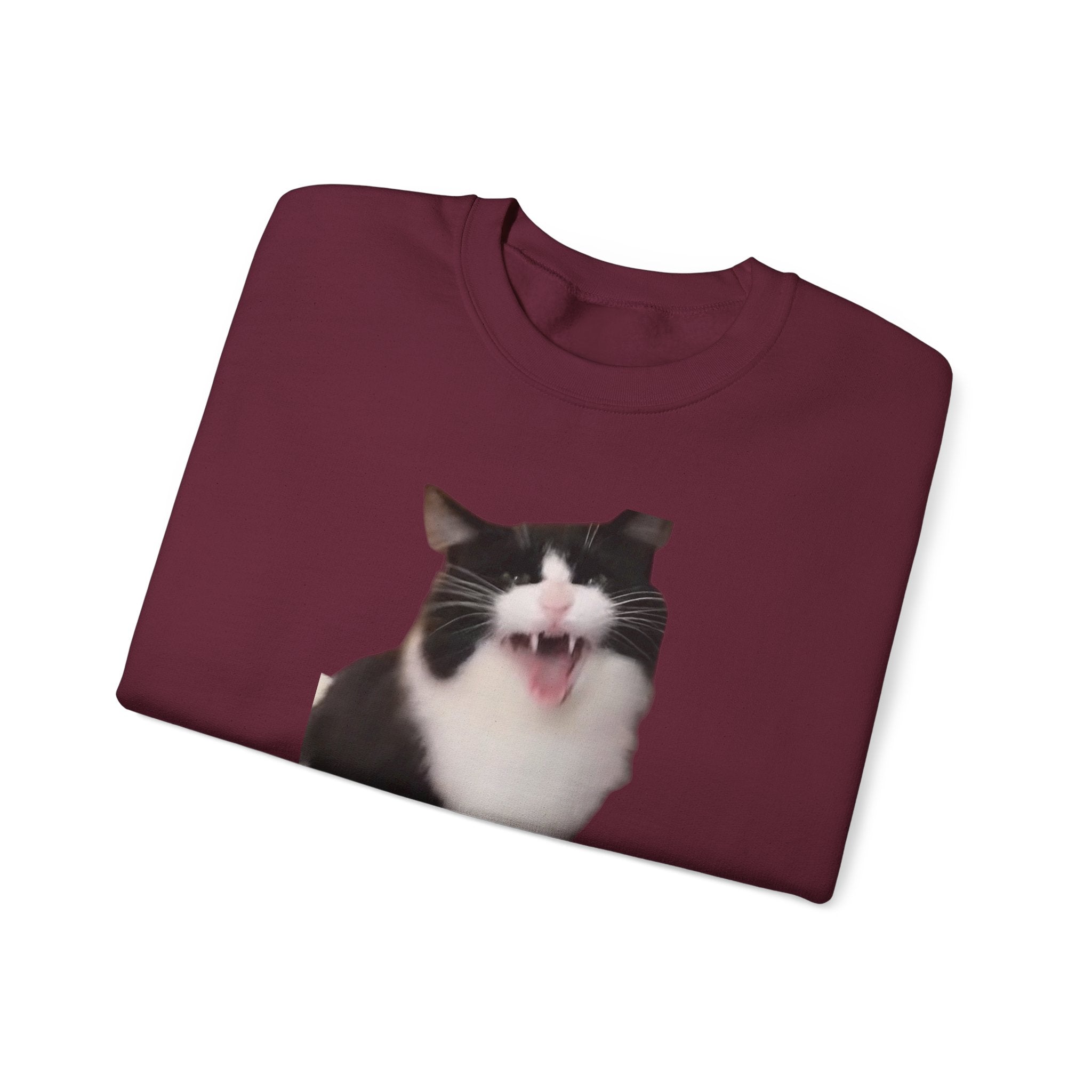 Maroon t-shirt with a cat graphic on a white background