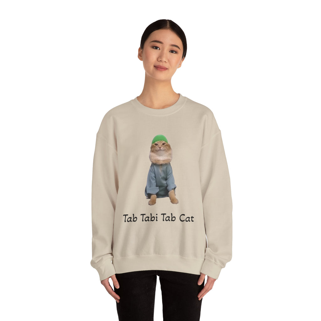 Person wearing a beige sweatshirt with a cat graphic and text on a white background
