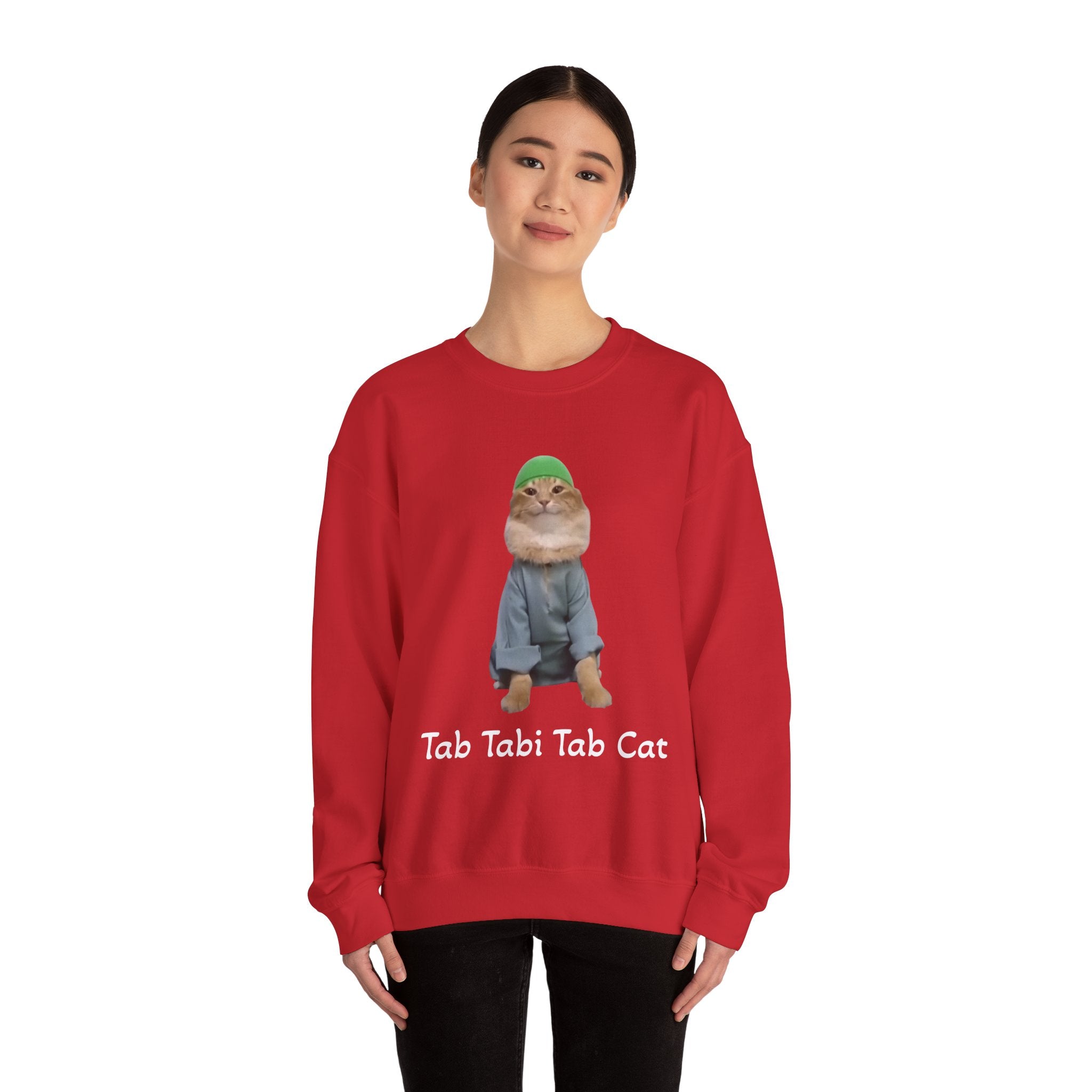 Person wearing a red sweatshirt with a cat graphic and text on a white background