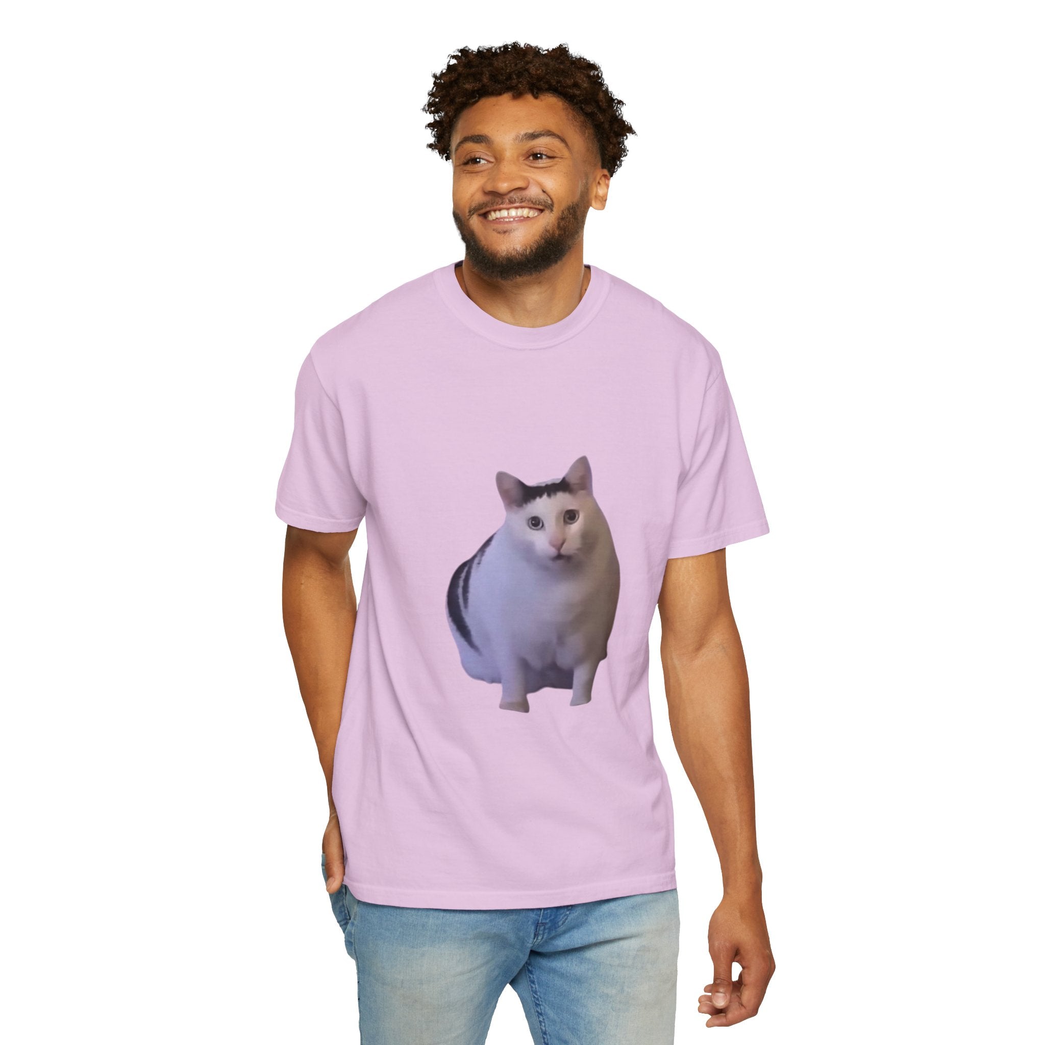Man wearing a light purple t-shirt with a cat graphic on a white background