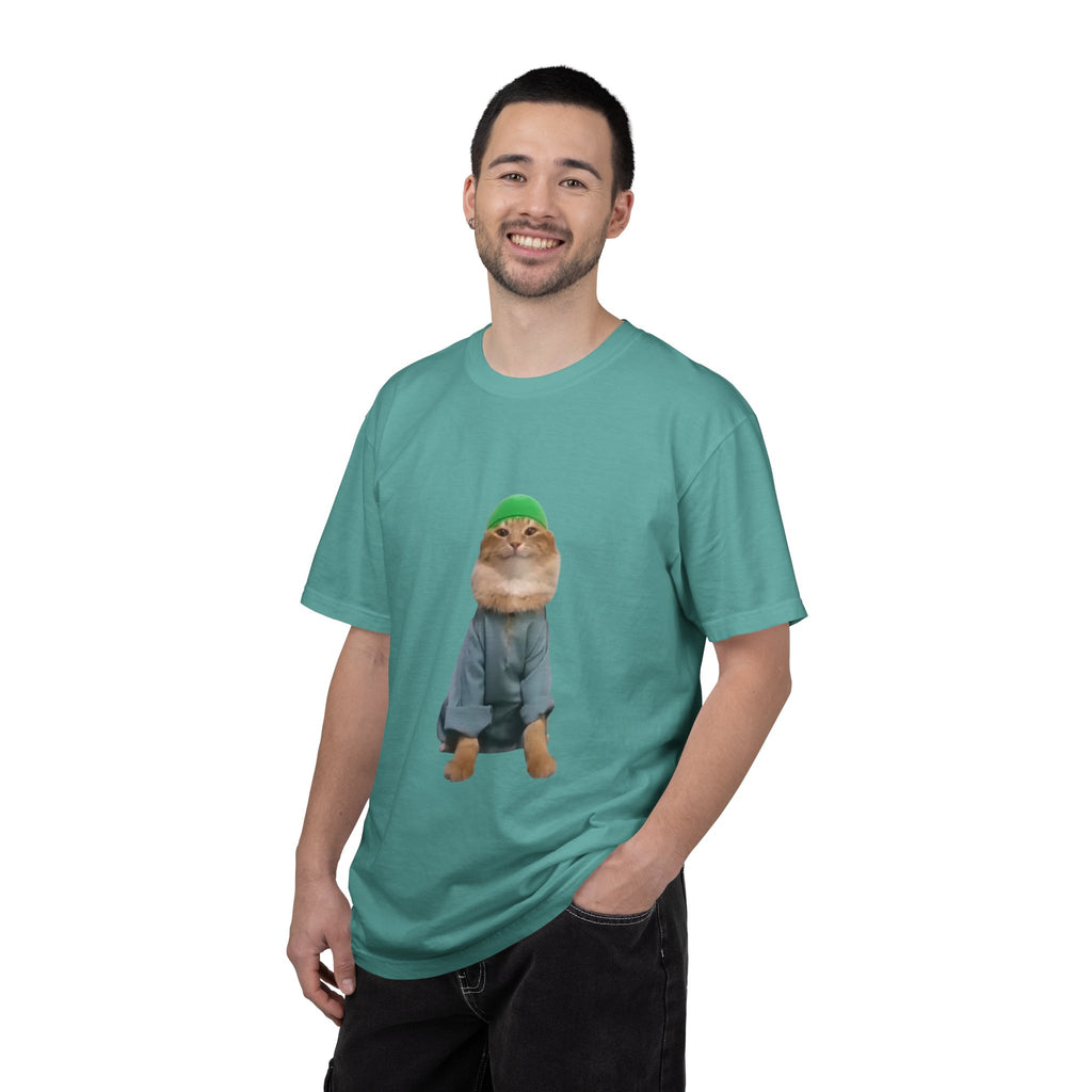 Man wearing a teal t-shirt with a graphic of a cat in a sweater and hat on a white background