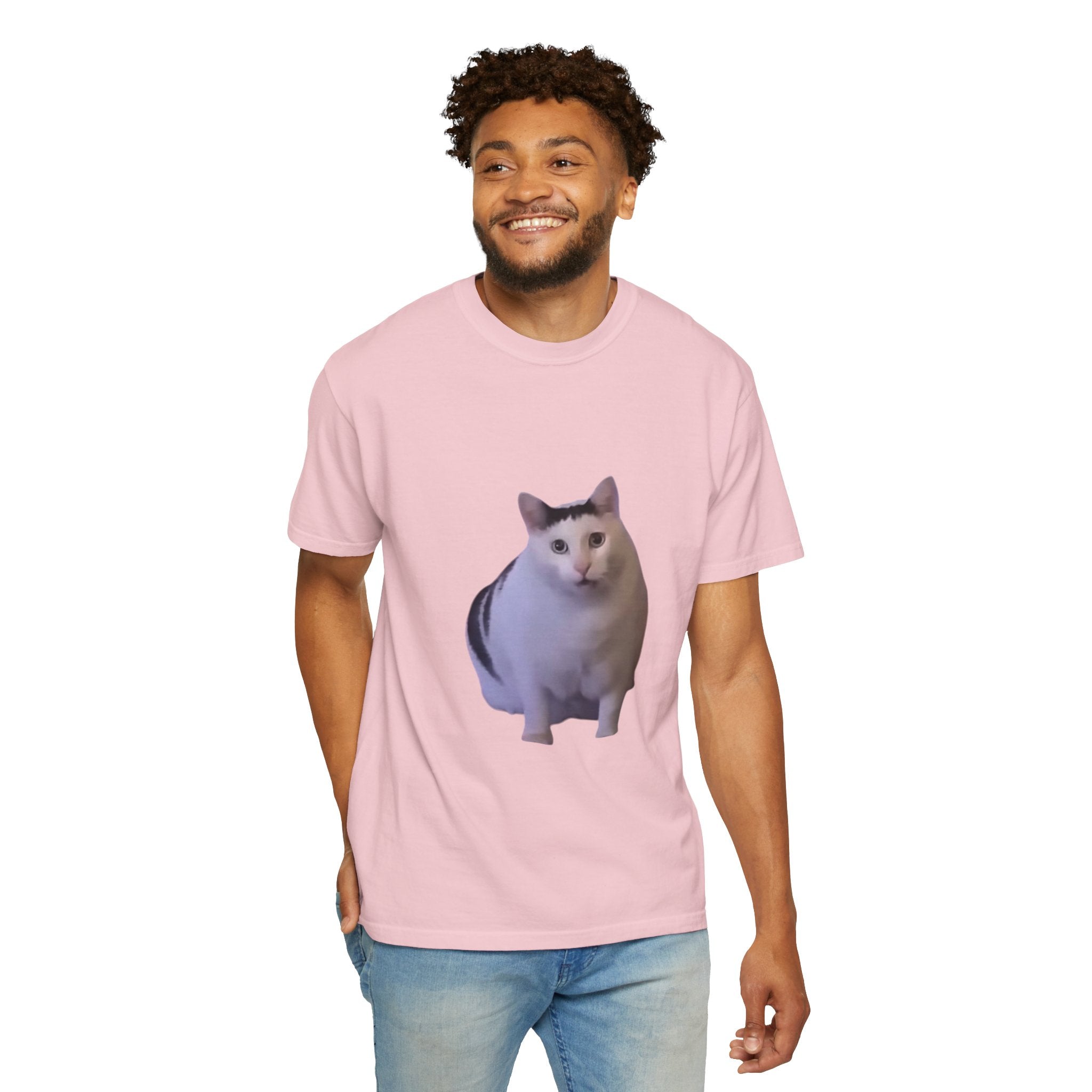 Man wearing a pink t-shirt with a cat graphic on a white background