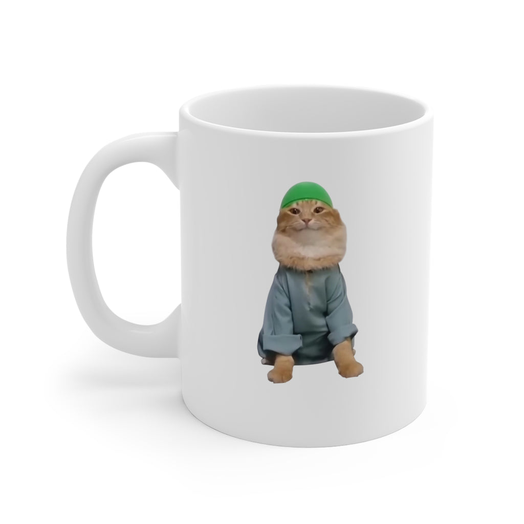 White mug with a cat wearing a green hat and gray outfit on a white background