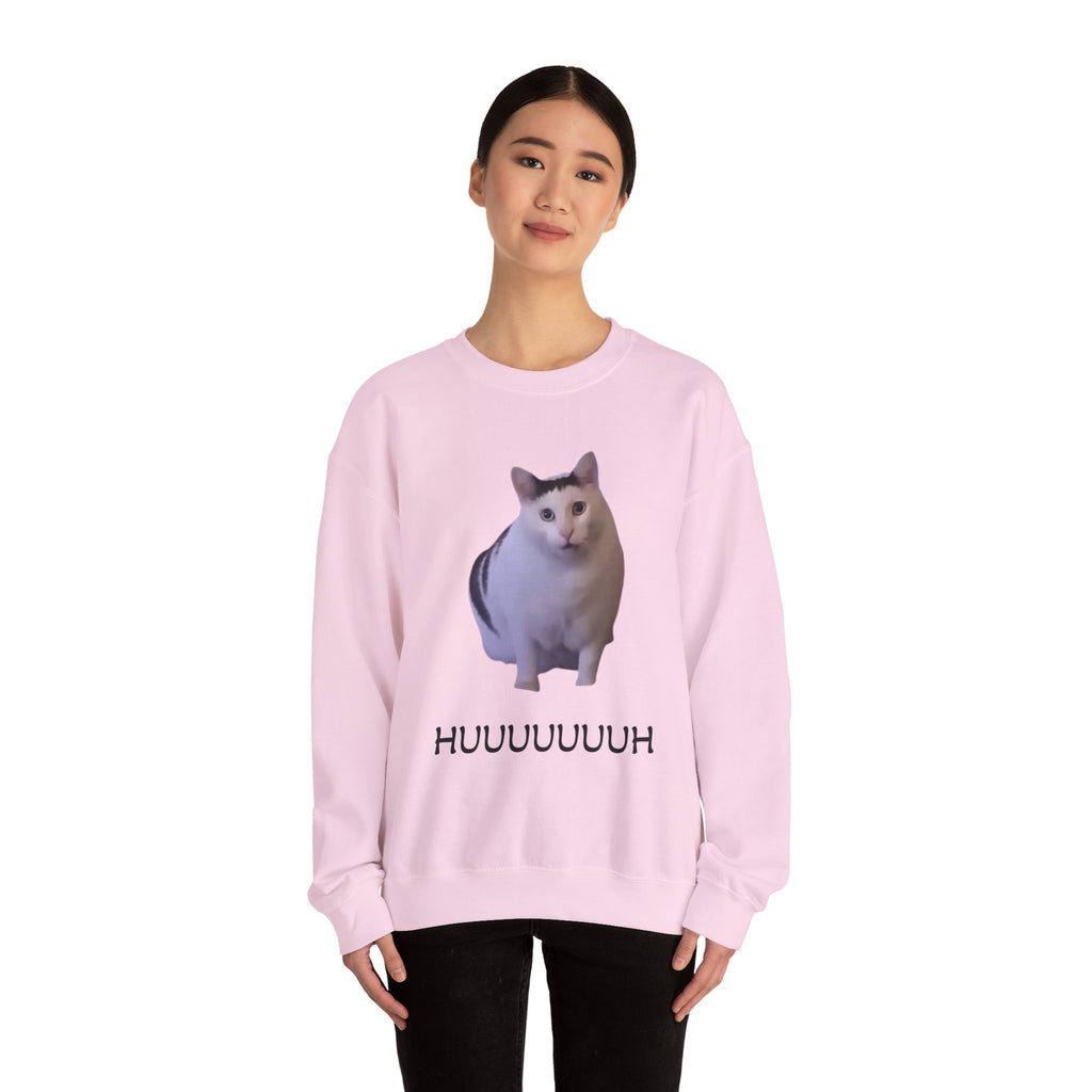 Person wearing a pink sweatshirt with a cat graphic and text on a white background