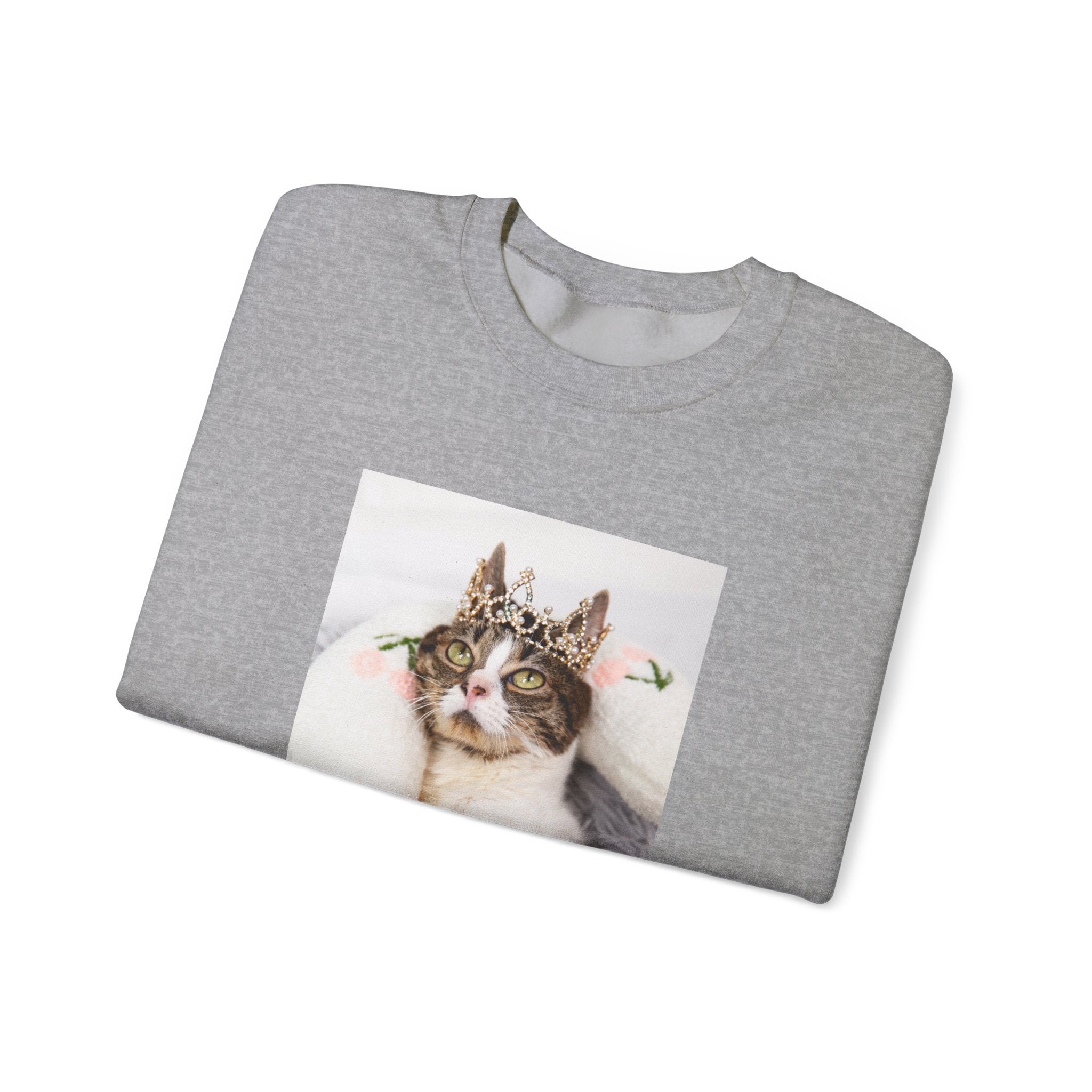 Folded gray t-shirt with a cat wearing a crown printed on it.