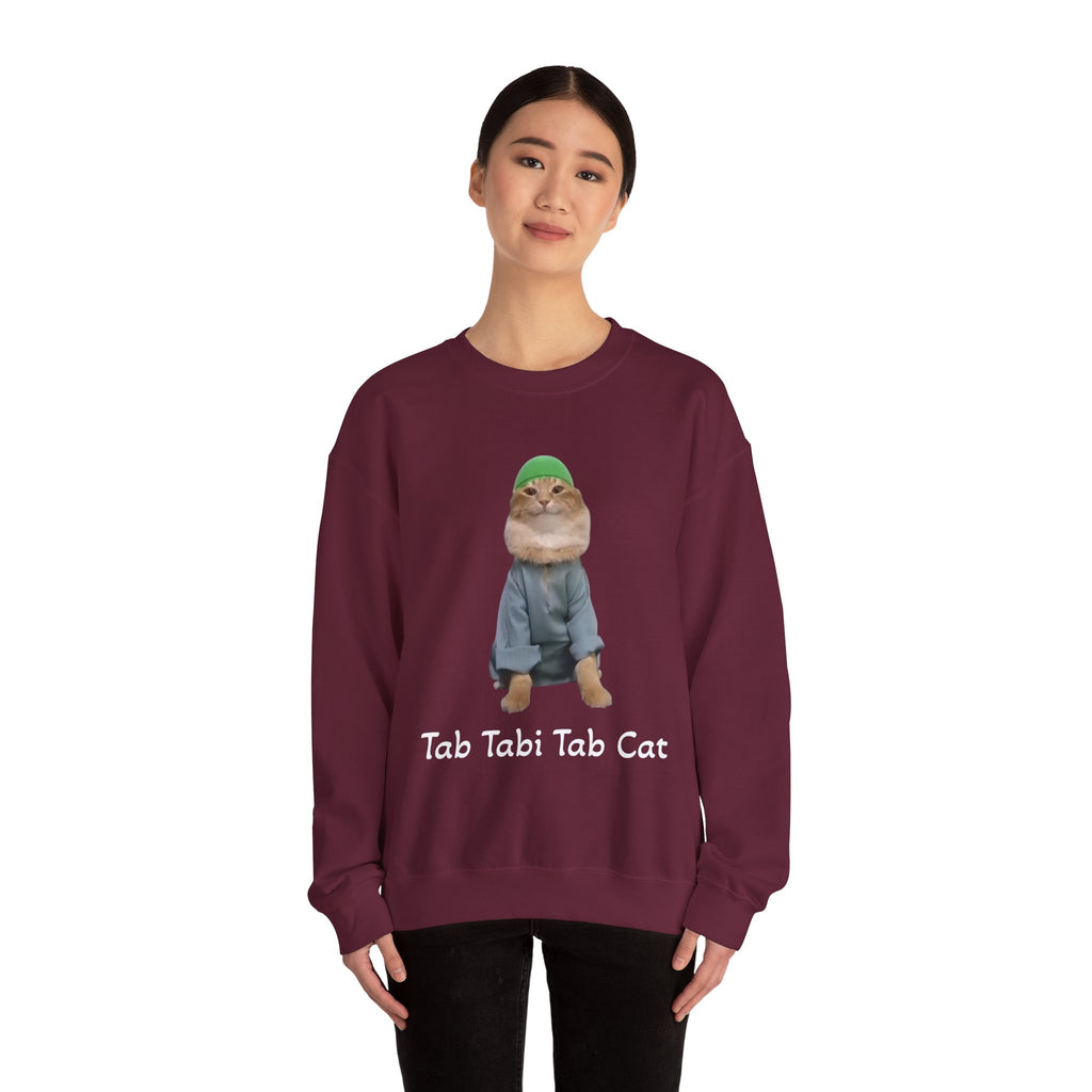 Person wearing a maroon sweatshirt with a cat graphic and text on a white background