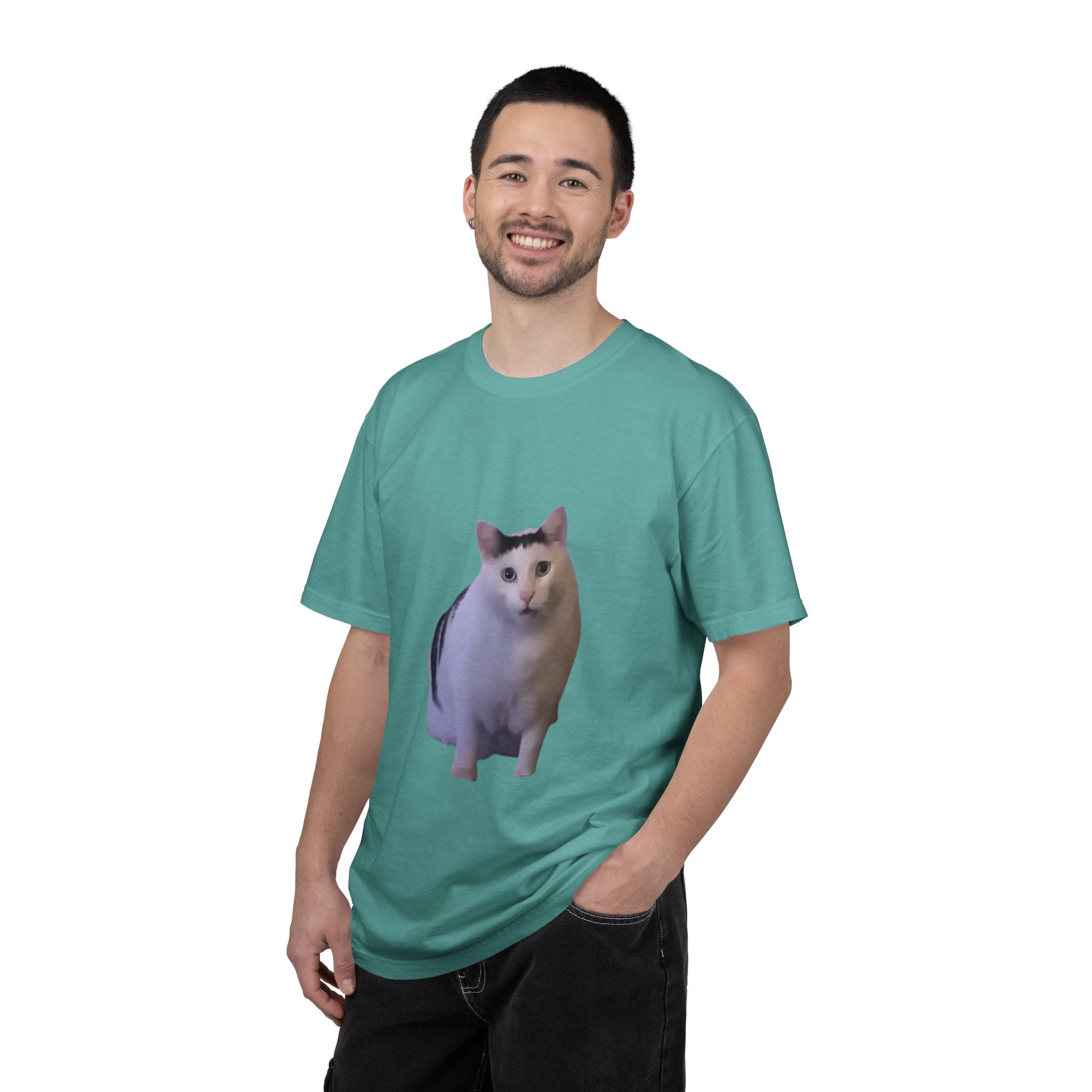 Man wearing a teal t-shirt with a cat graphic on a white background