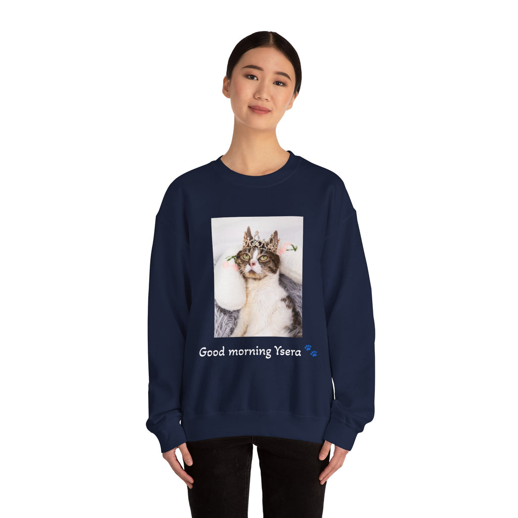 Person wearing a navy blue sweatshirt with a cat graphic and text on a white background