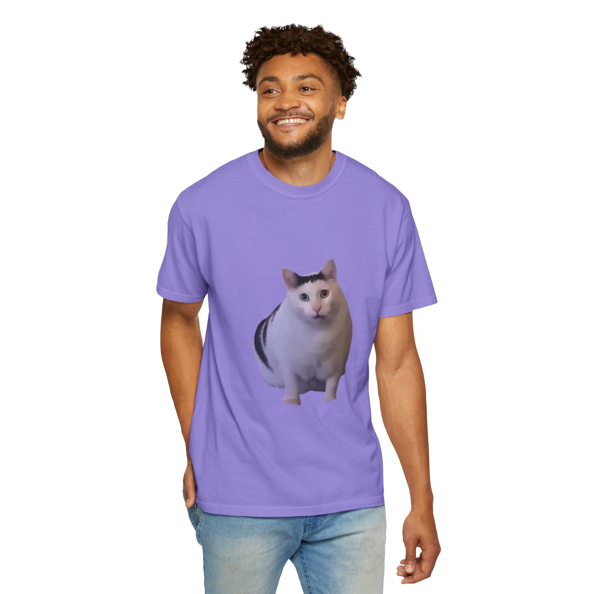 Man wearing a purple t-shirt with a cat graphic on a white background