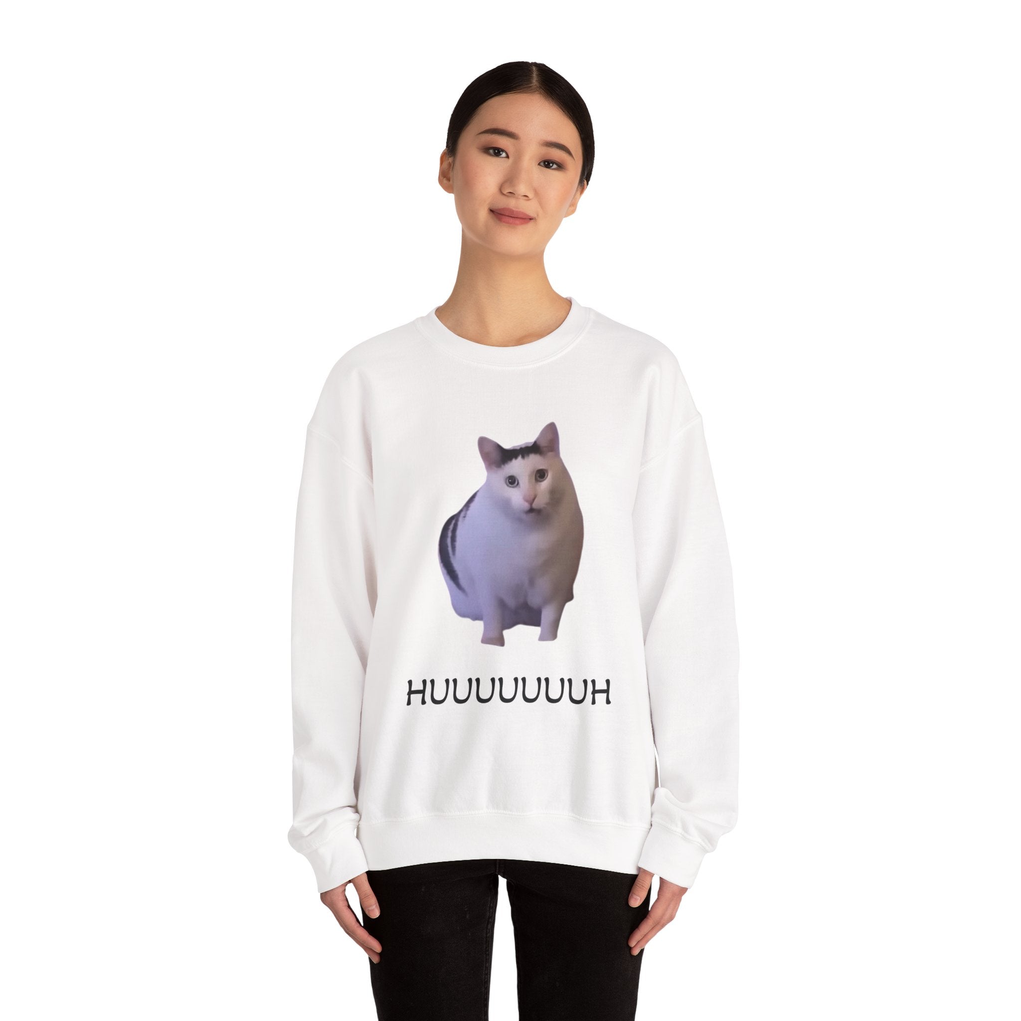 Person wearing a white sweatshirt with a cat graphic and text on a white background