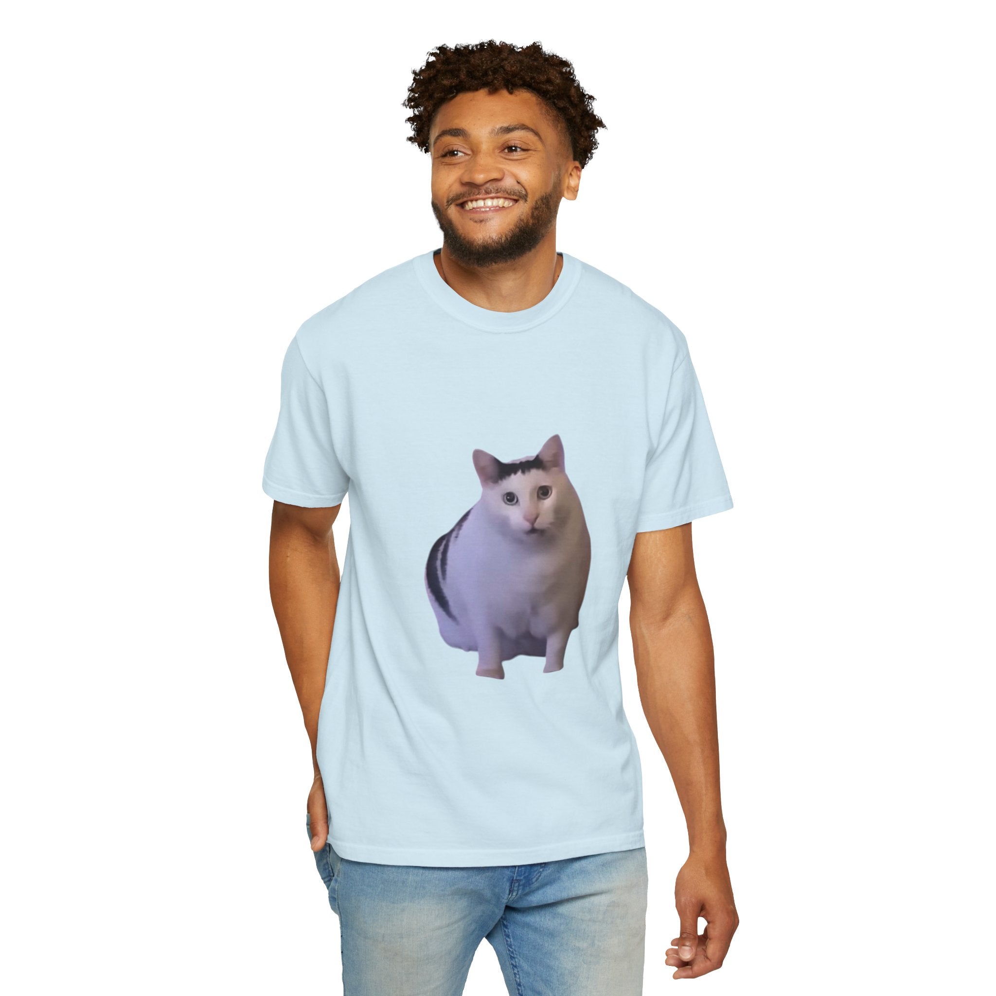Man wearing a light blue t-shirt with a cat graphic on a white background