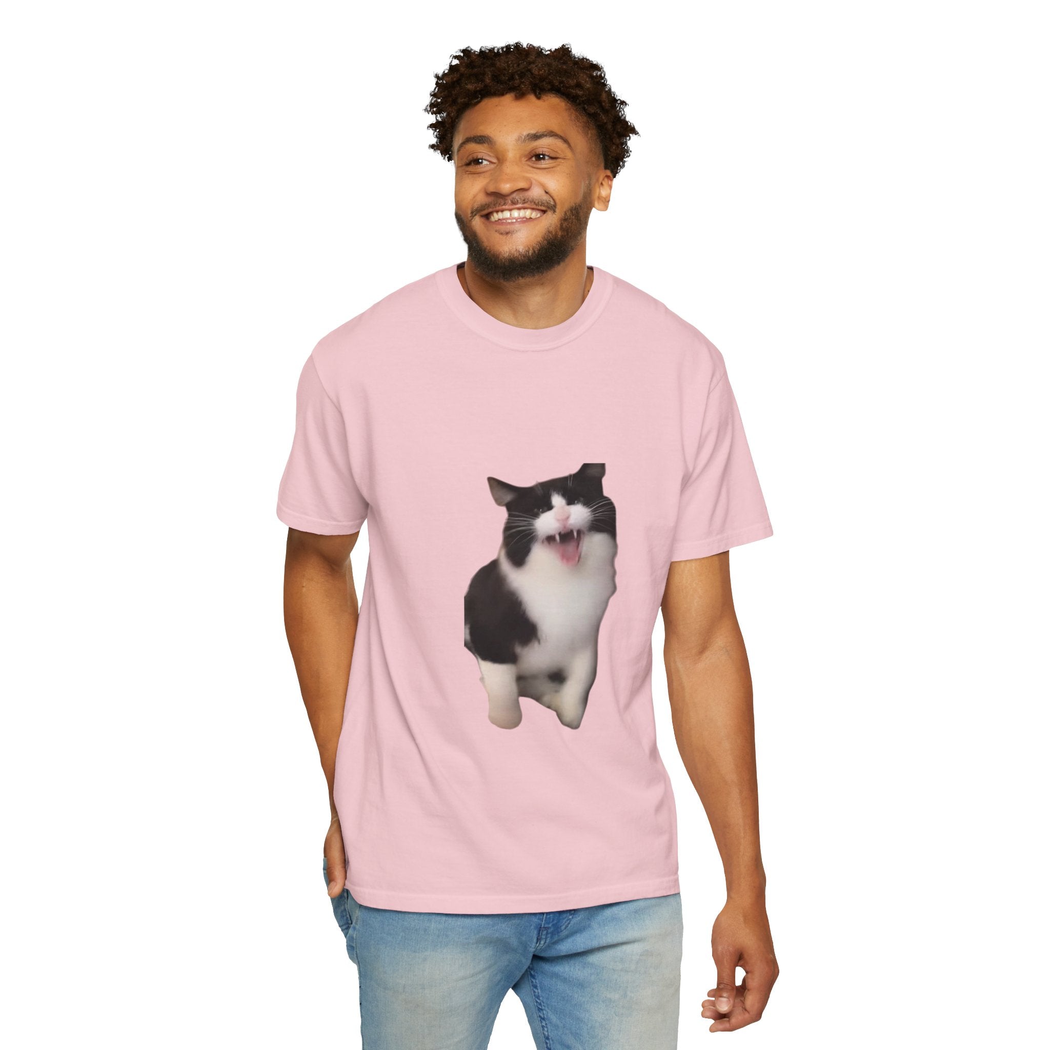 Man wearing a pink t-shirt with a cat graphic on a white background